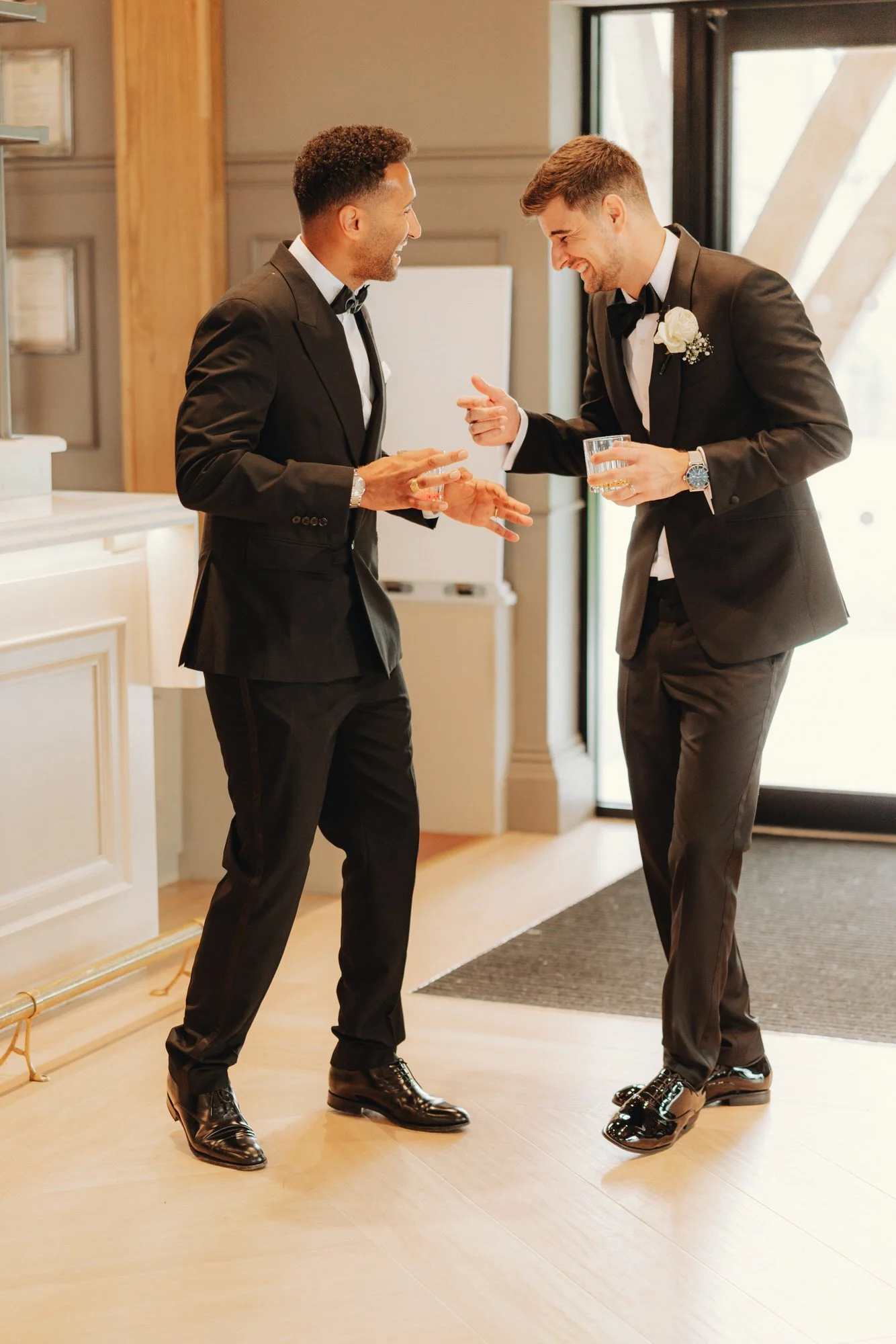 Jonathan sharing a drink with a groomsman
