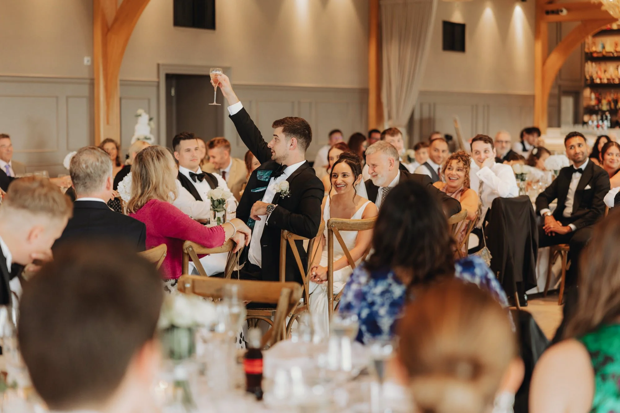 A speaker raising an arm as guests watch the speeches