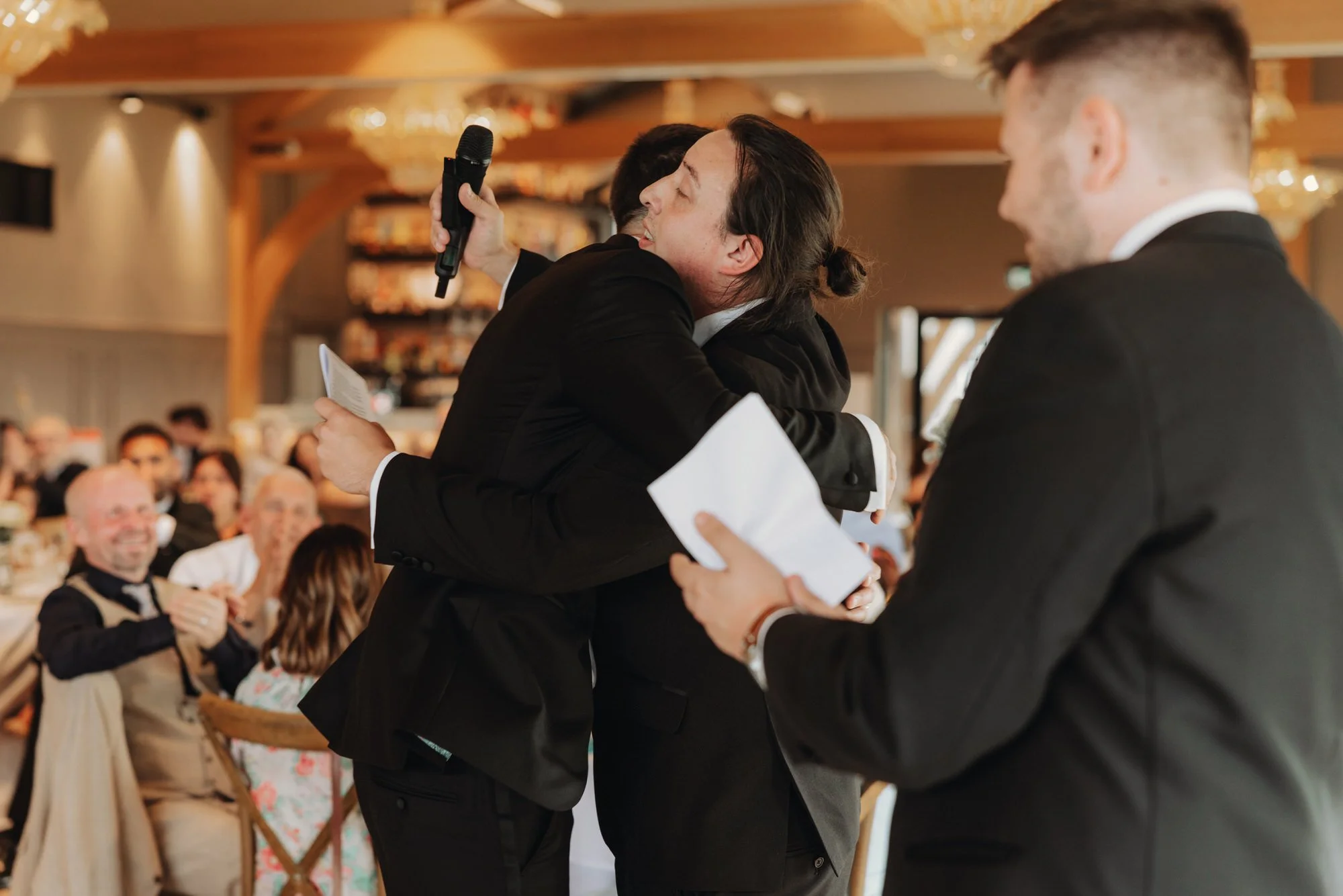 Caterina greeting a speaker with a hug