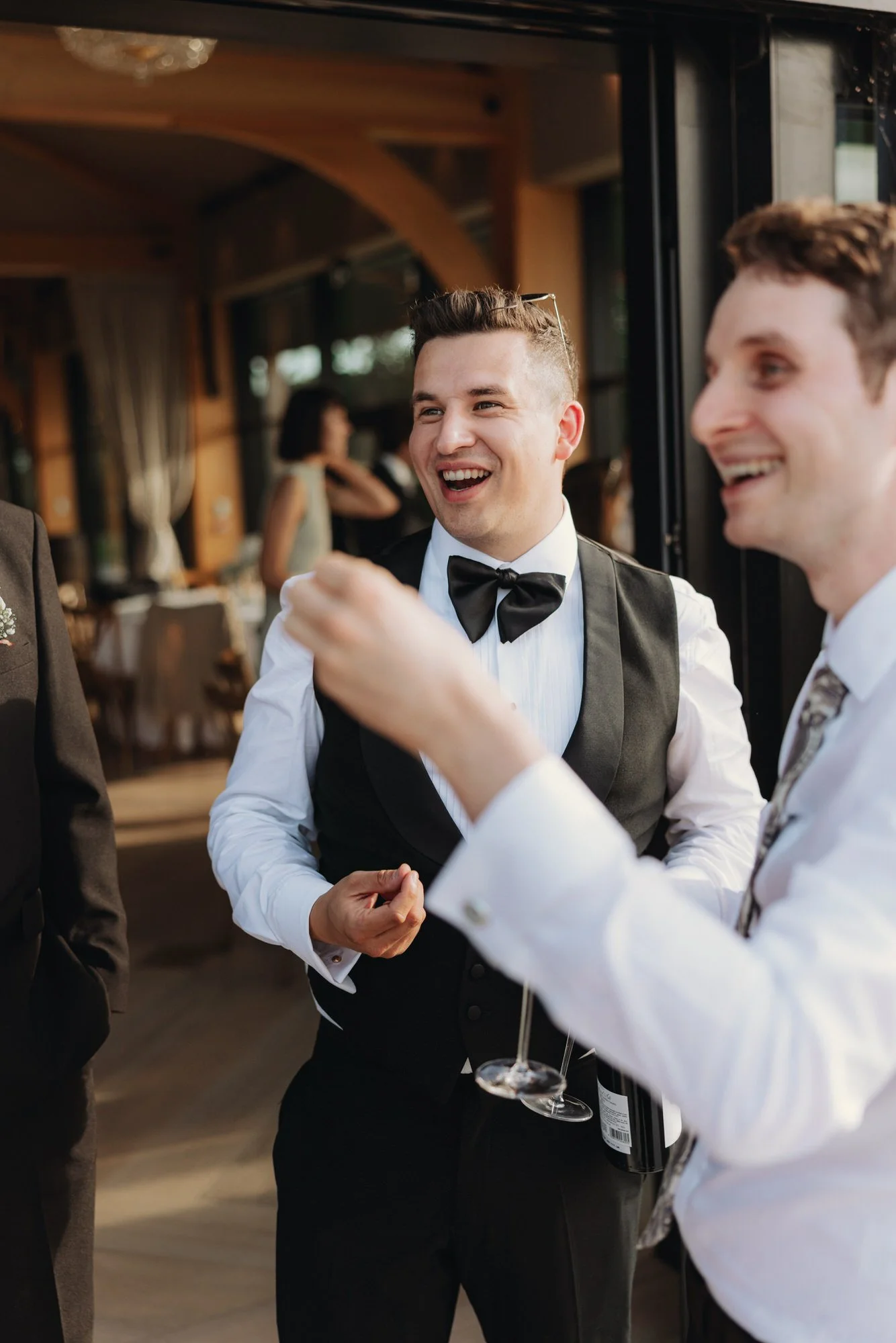 Jonathan laughing with a guest during the reception