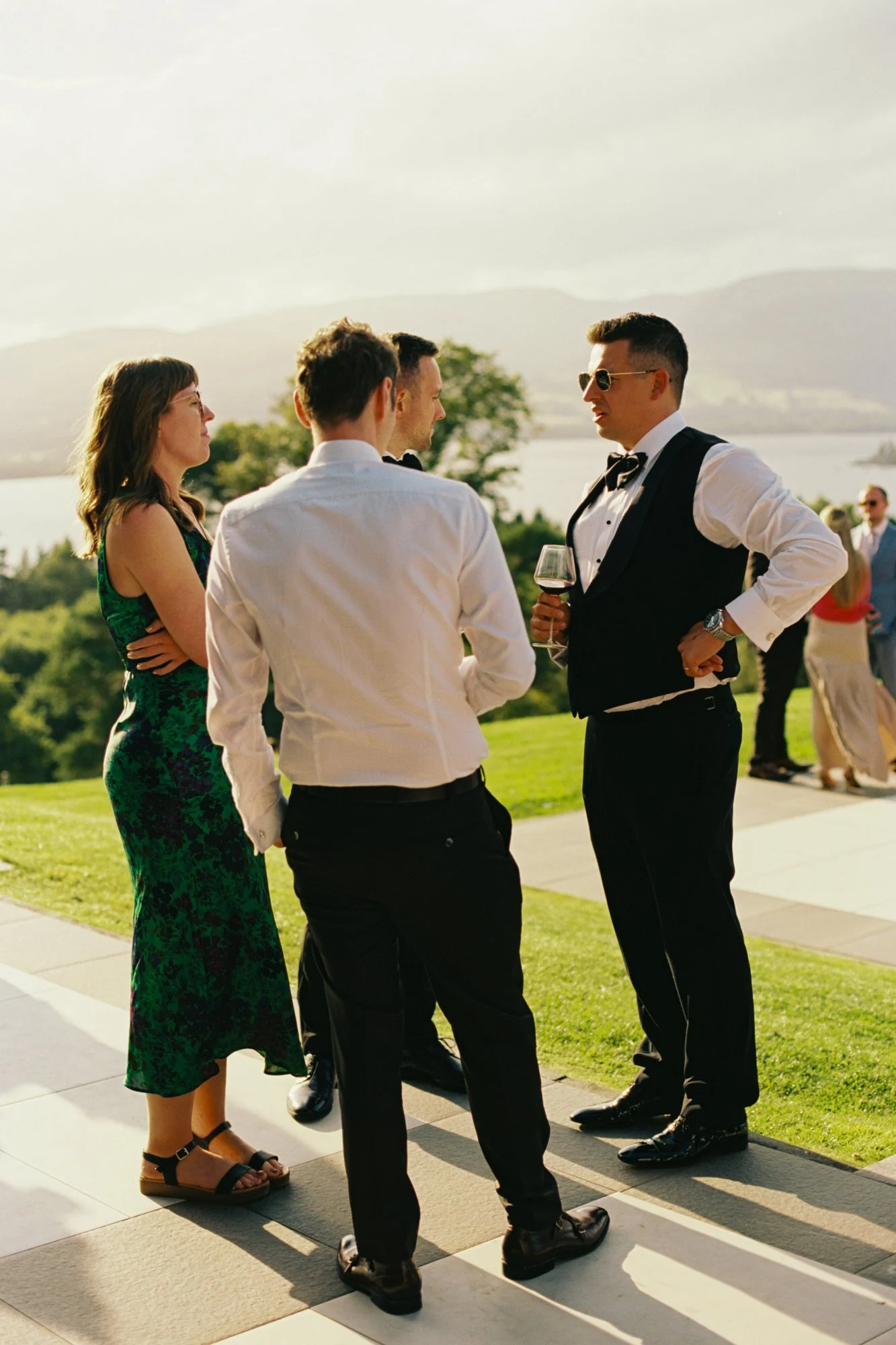 Guests talking on the terrace in the evening light
