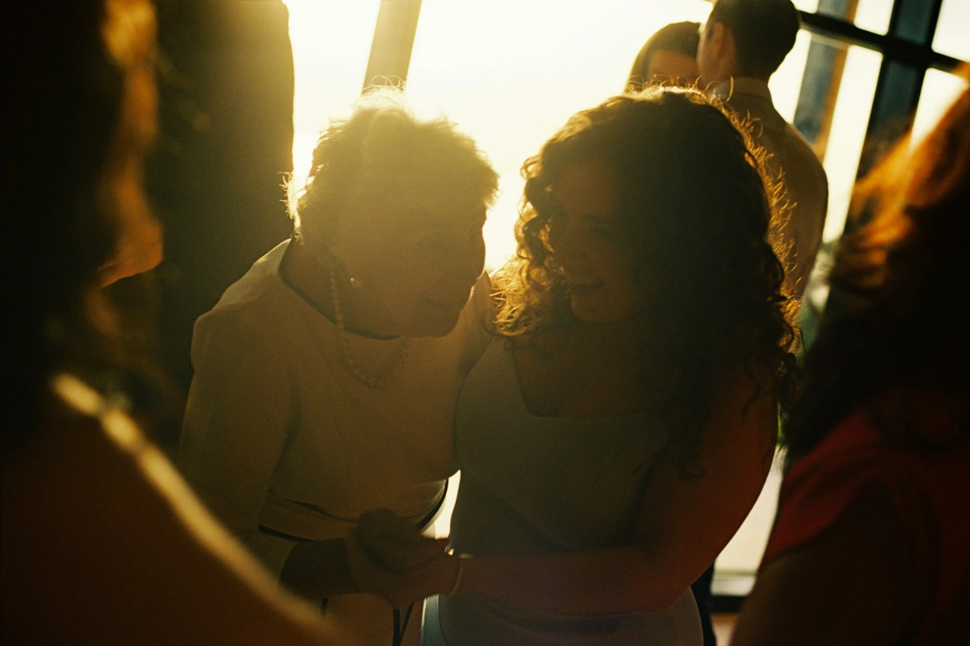 Warm evening sunlight falling on guests inside the pavilion