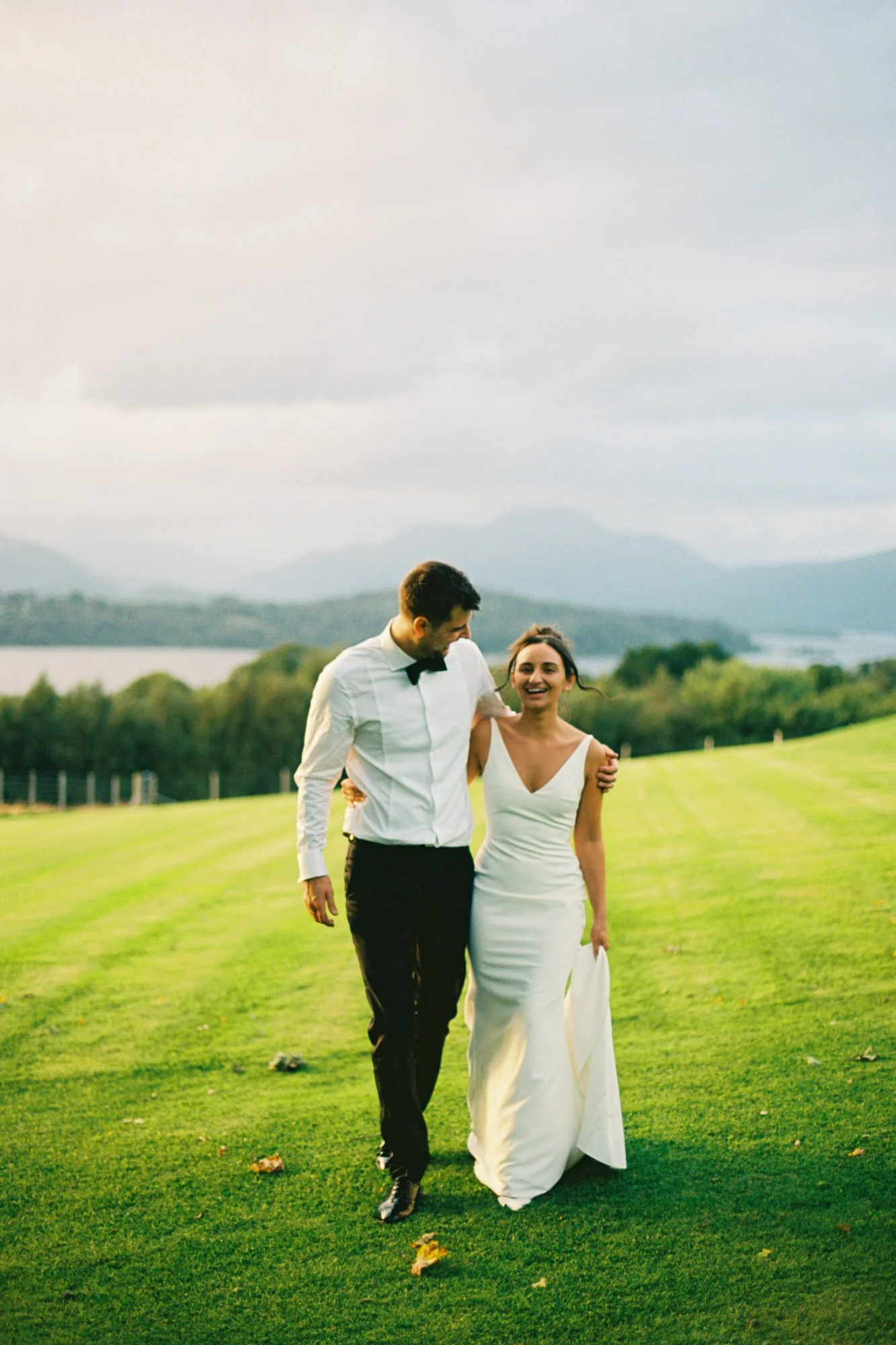 The couple walking across the lawn overlooking Loch Lomond
