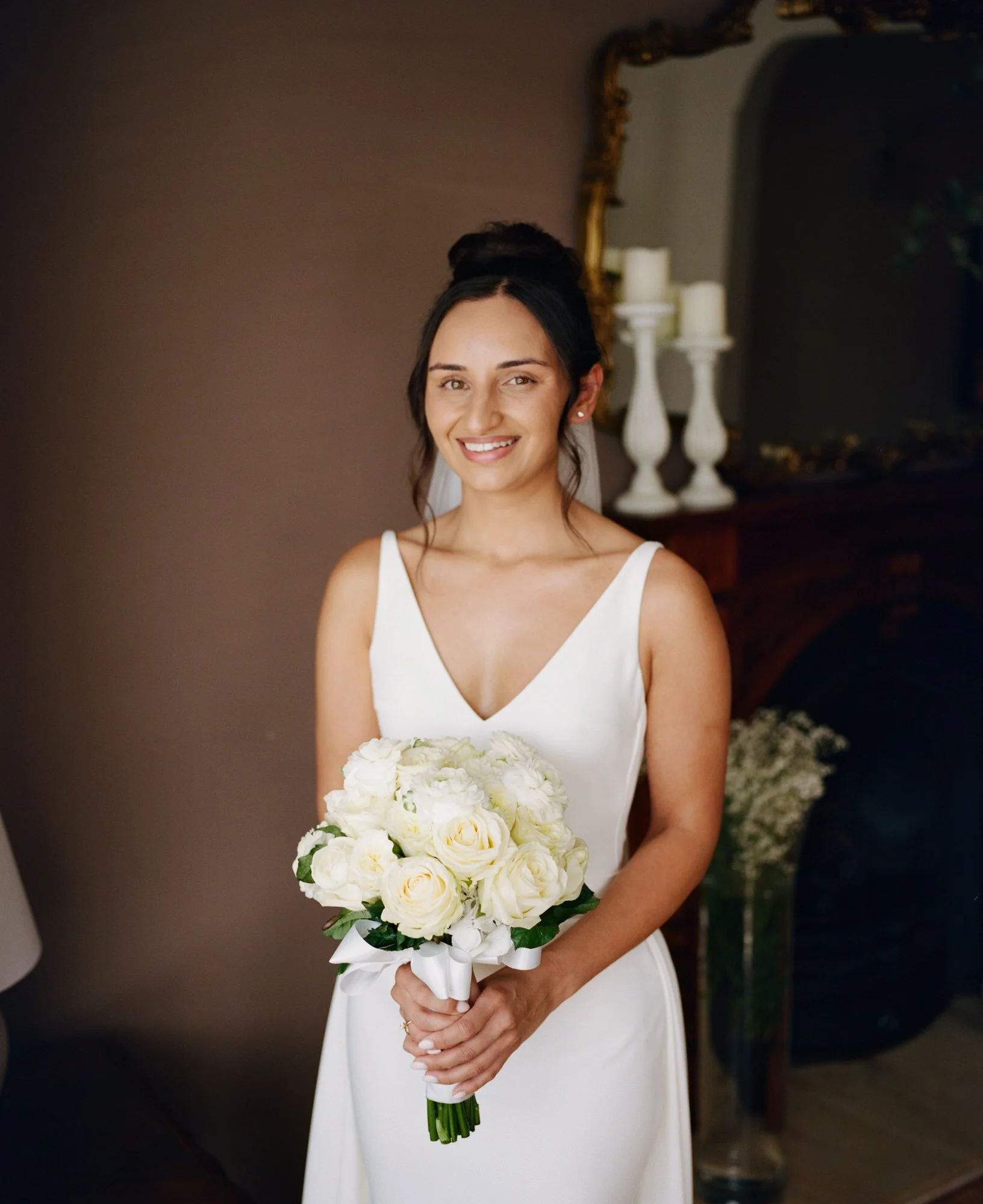 Caterina holding her white bouquet for a bridal portrait