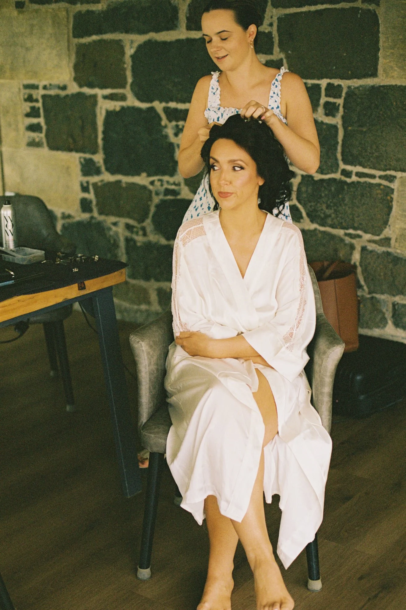 Claire having her hair styled during morning preparations