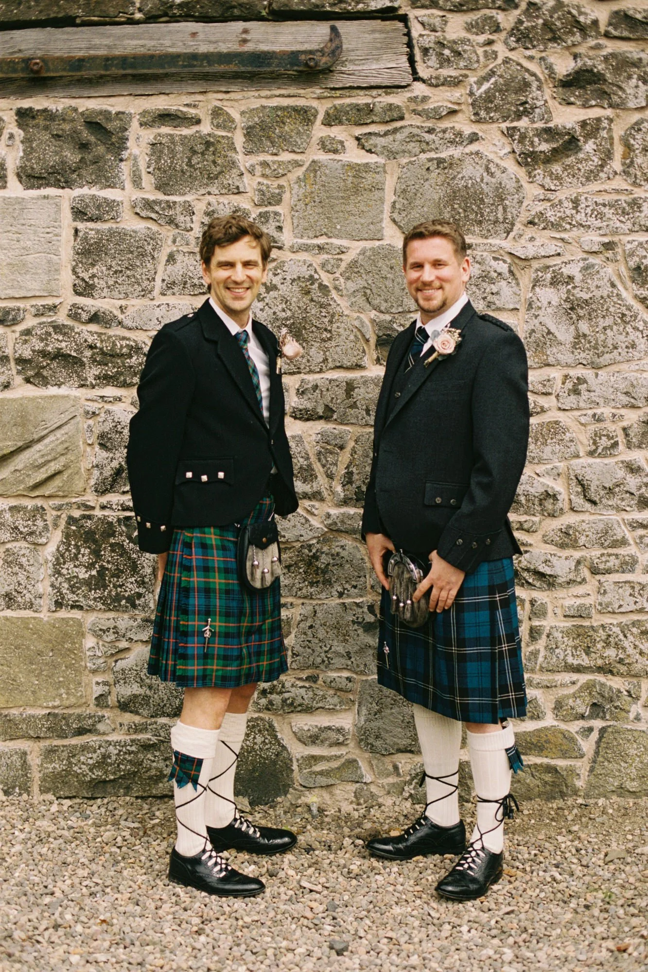 Two wedding guests in tartan kilts at Pratis Barns