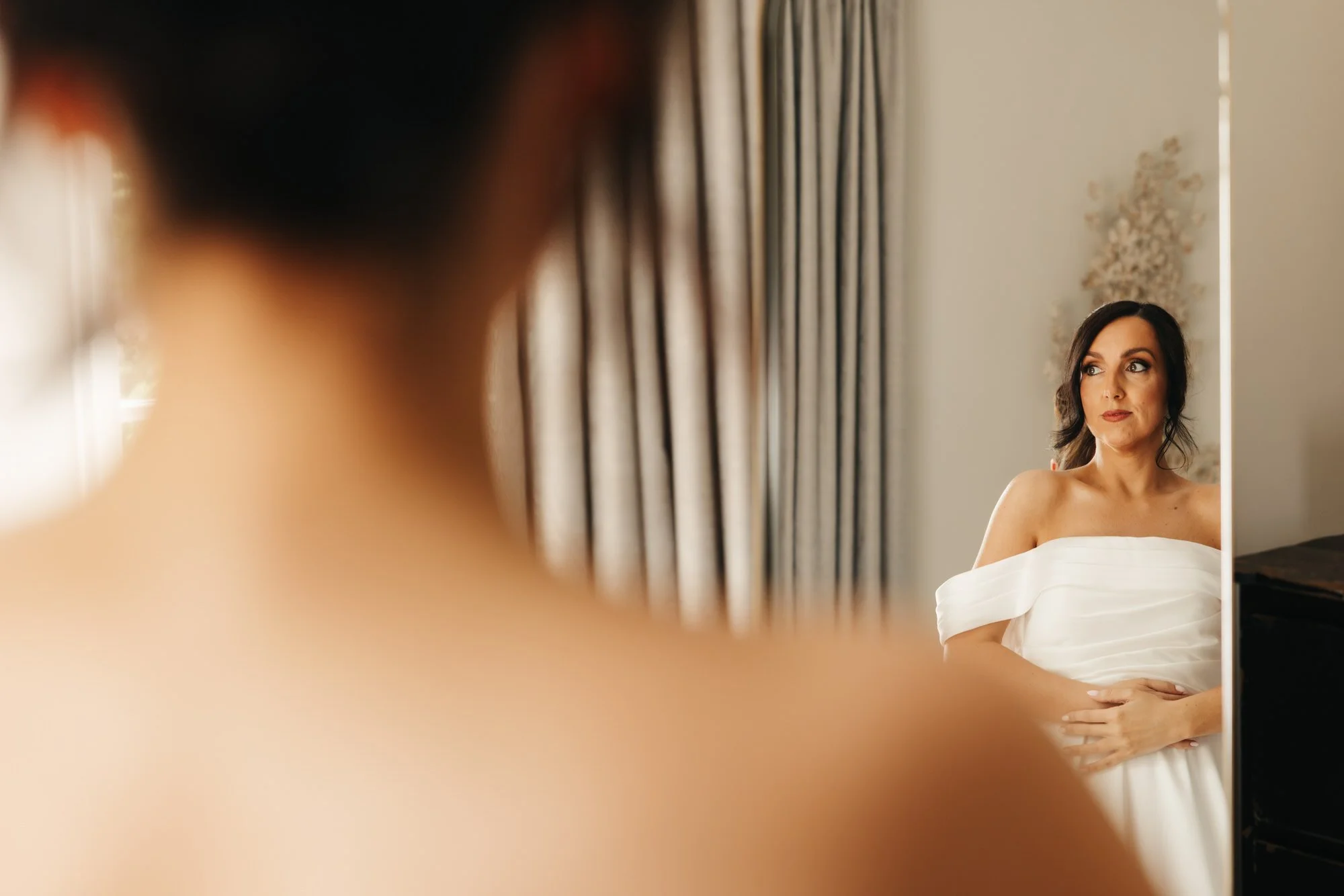 Claire reflected in a mirror while getting ready