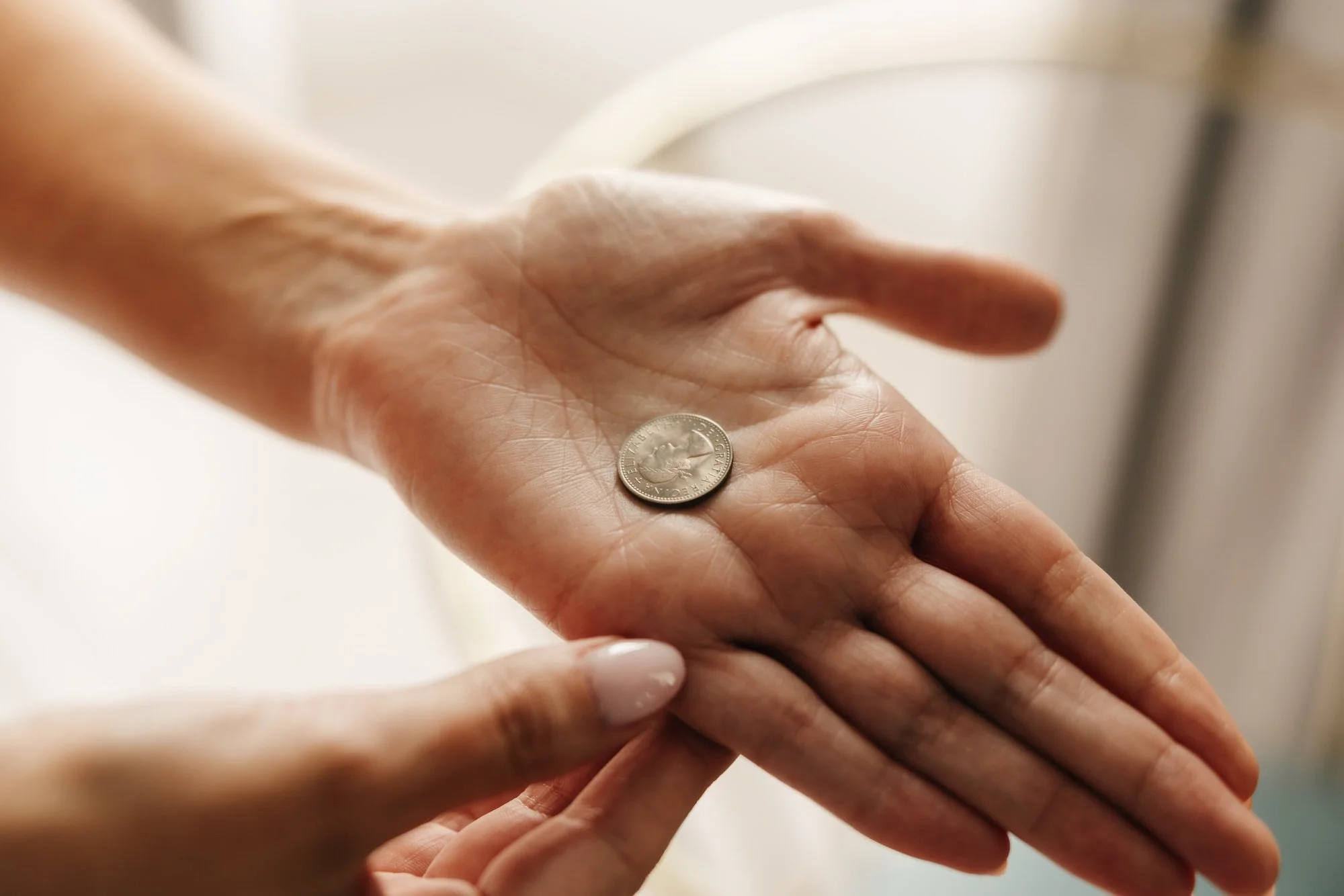 Hands holding a small keepsake during bridal preparations