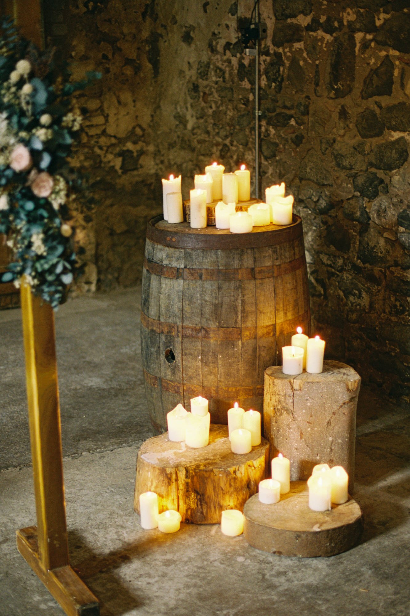 Candles on wooden barrels inside The Stables