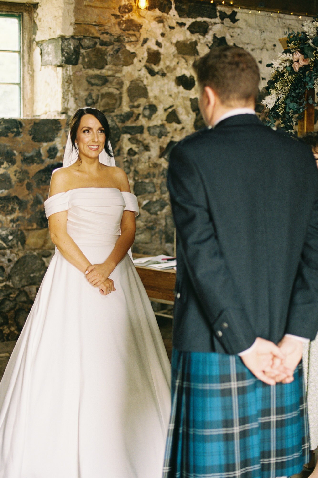 Claire and Alex facing each other during their vows