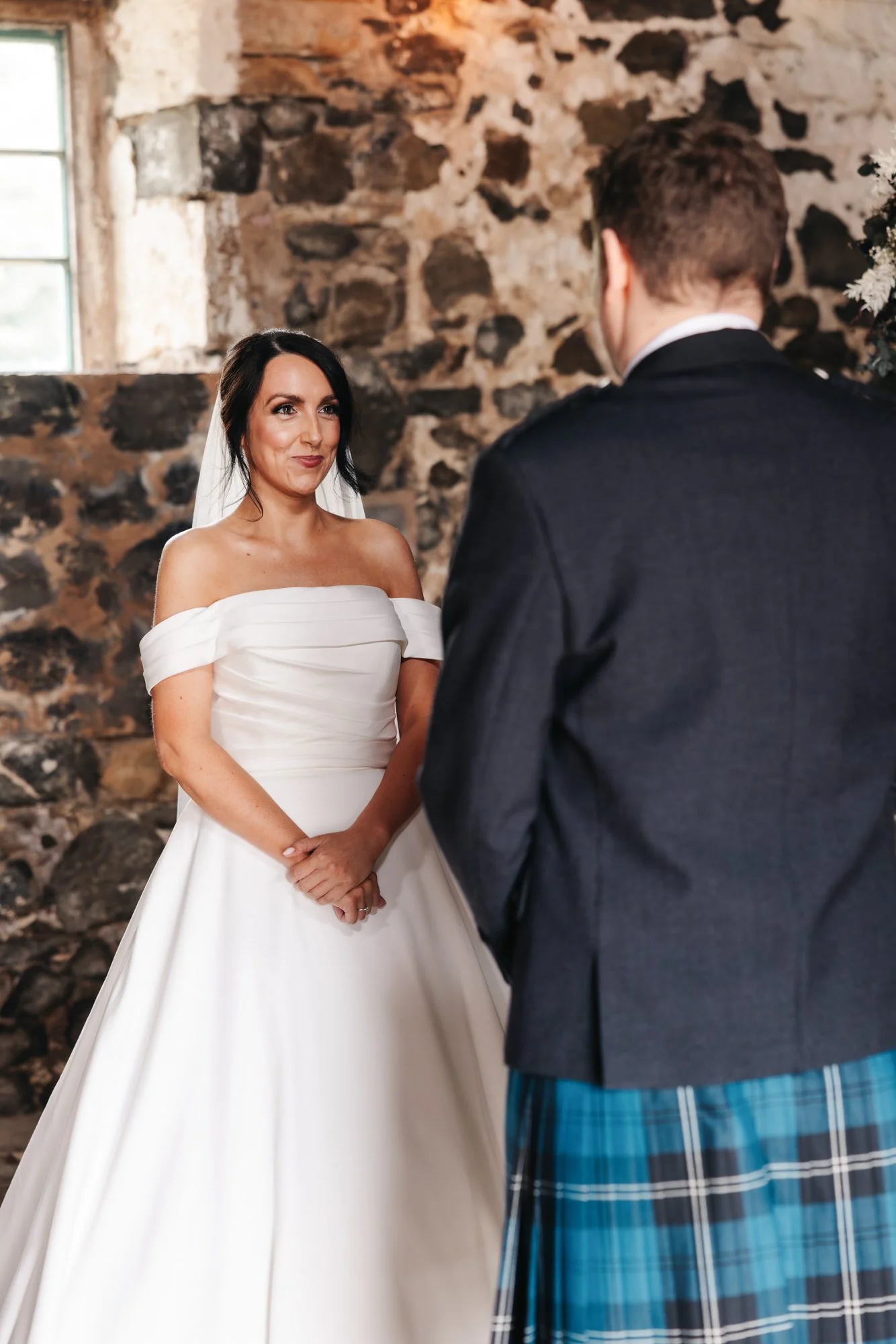 Bride smiling at the groom during the ceremony