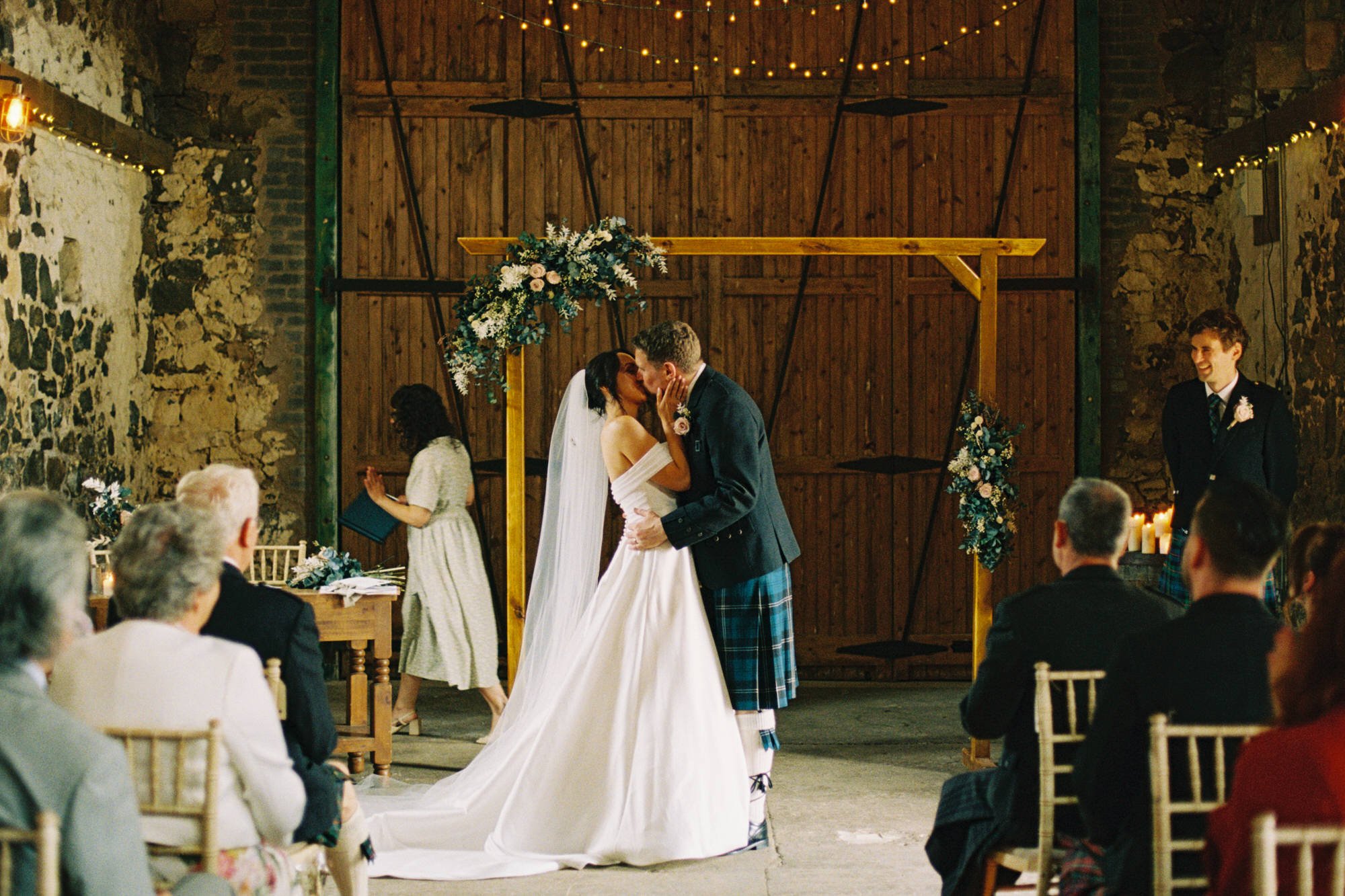 Claire and Alex kissing at the end of their ceremony