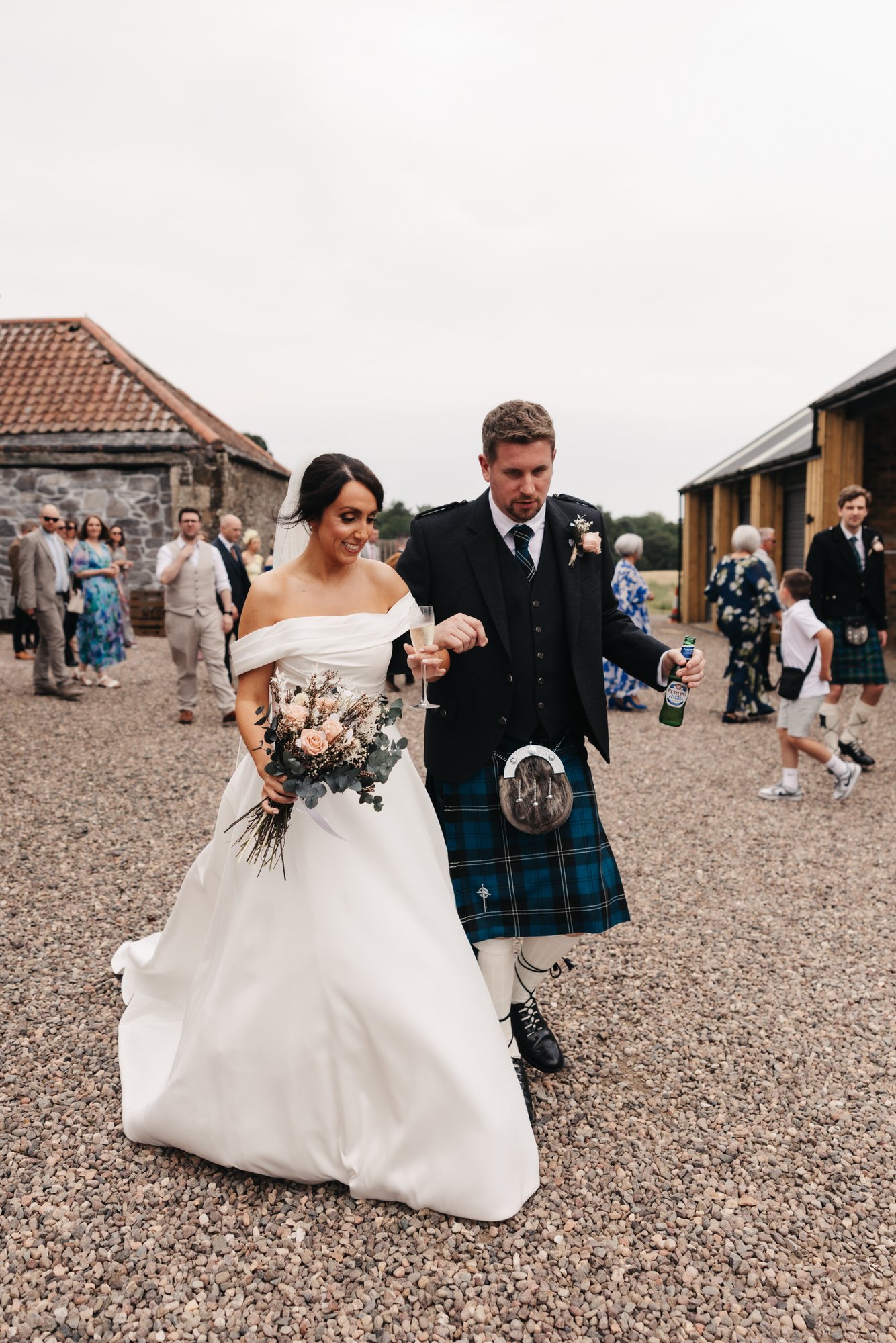 Claire and Alex walking across the barn courtyard