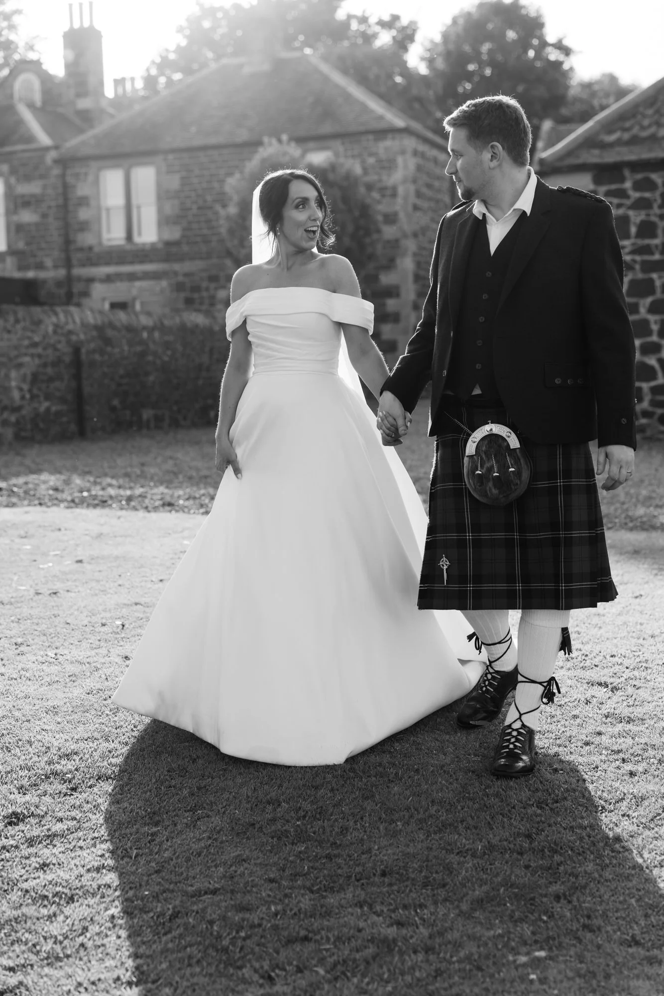 Black and white portrait of the couple outside Pratis House
