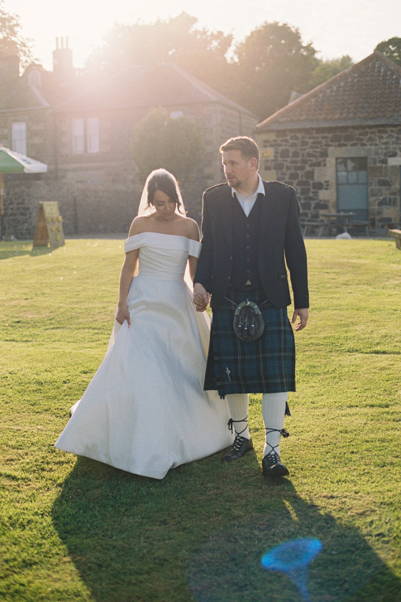 Claire and Alex walking on the lawn in late sunshine