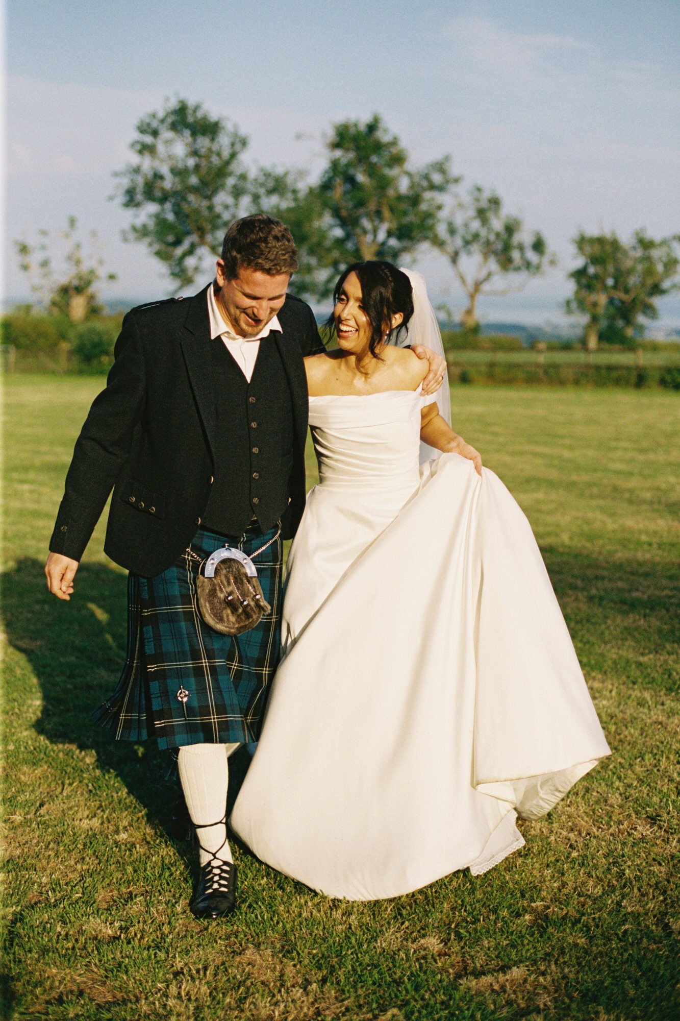 Claire and Alex smiling together in the evening light