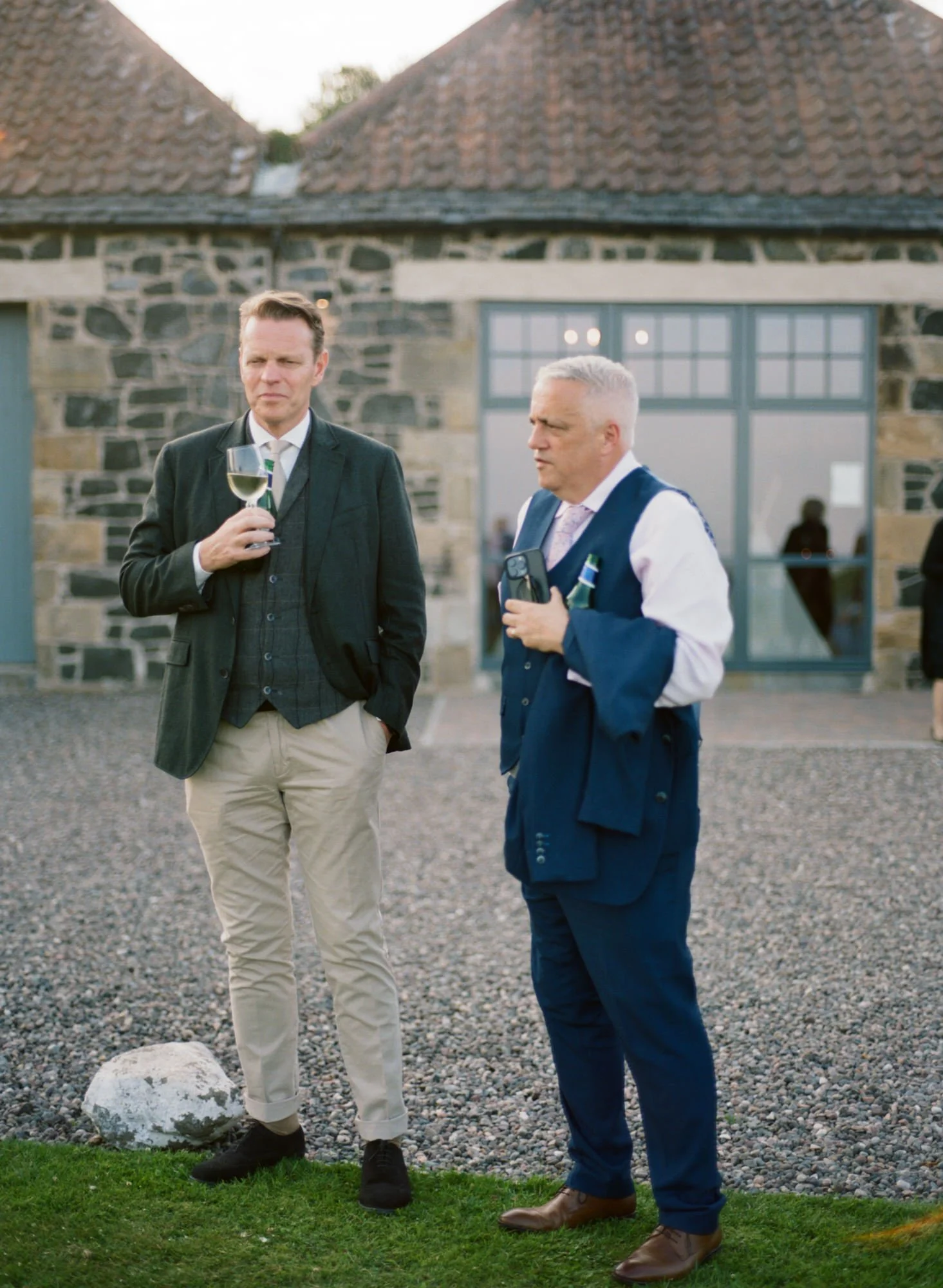 Alex talking with a guest on the lawn at Pratis Barns
