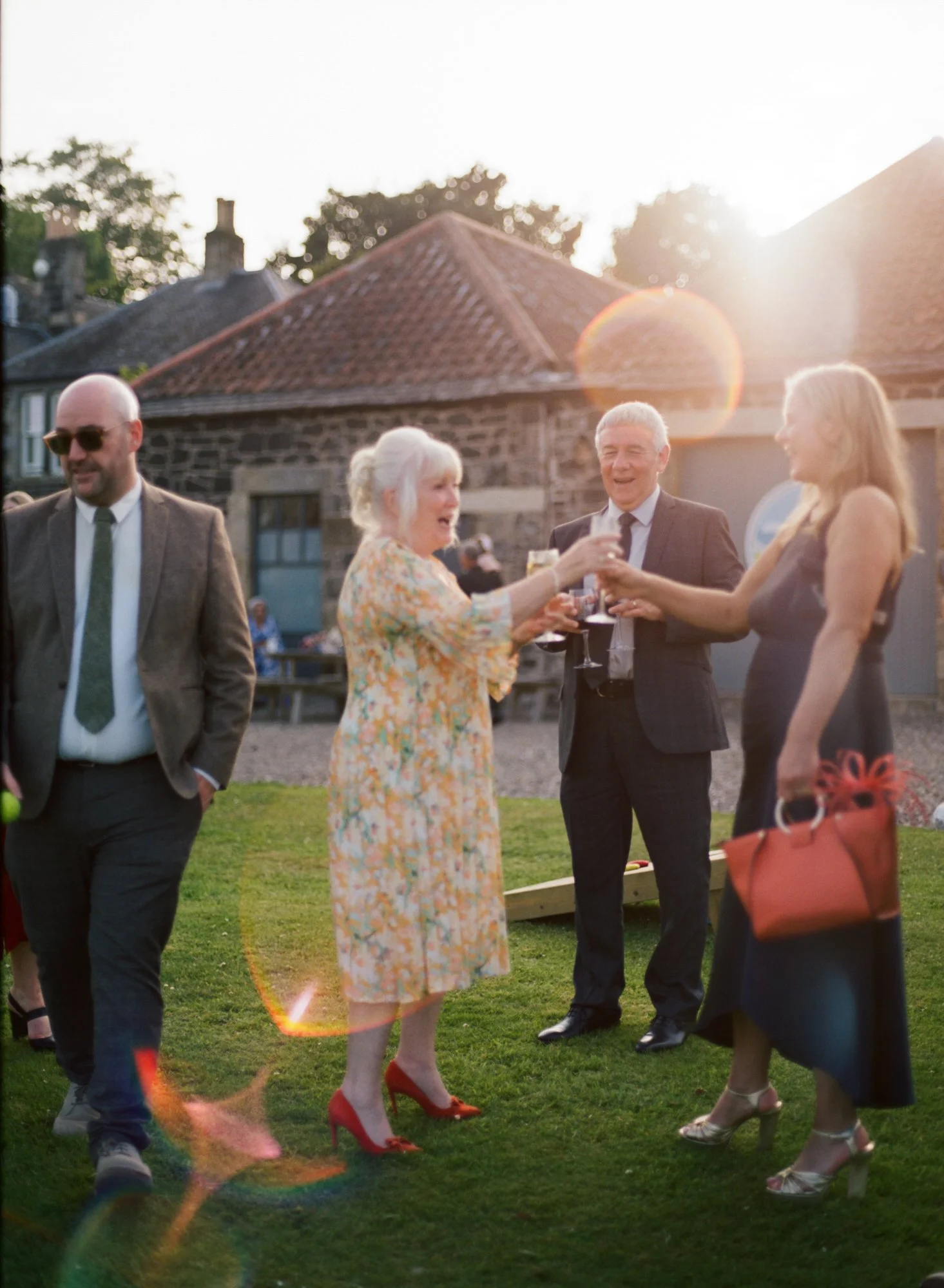Guests laughing together in the evening sunshine