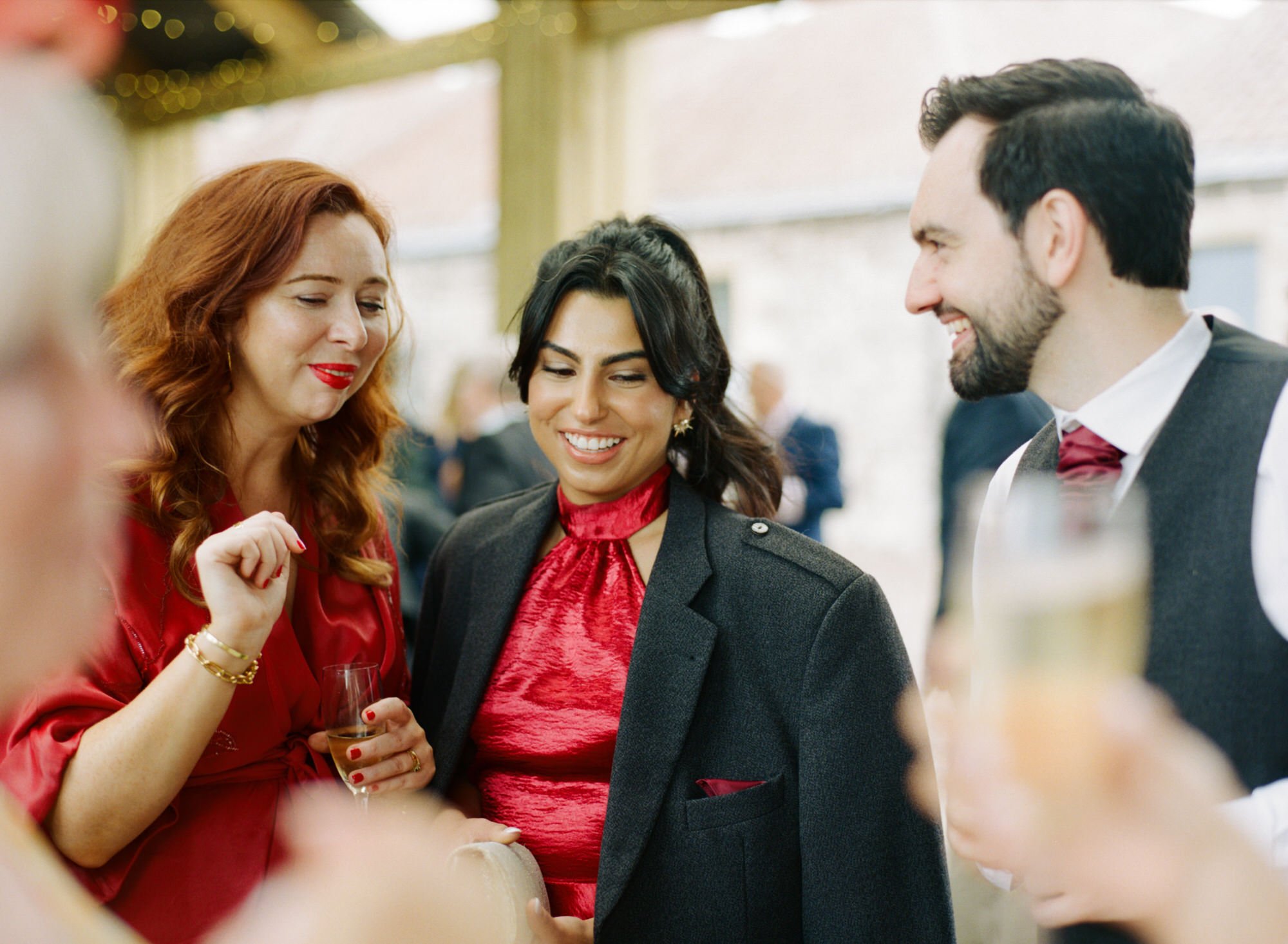 Wedding guests chatting over drinks outdoors