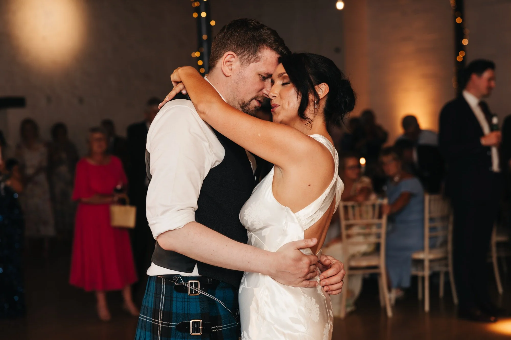 Claire and Alex embracing during their first dance