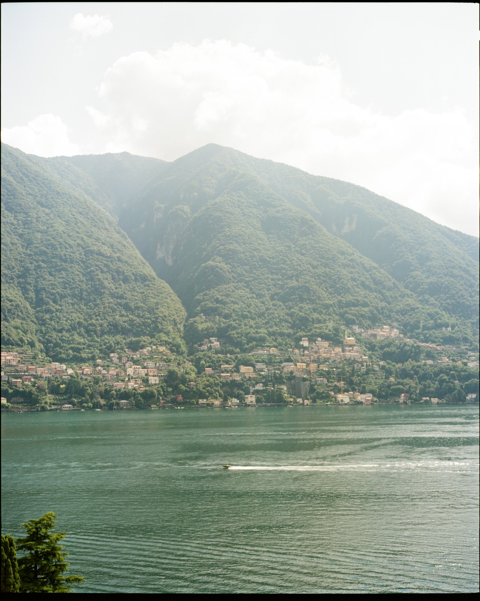 Mountains and lakeside buildings reflected in Lake Como