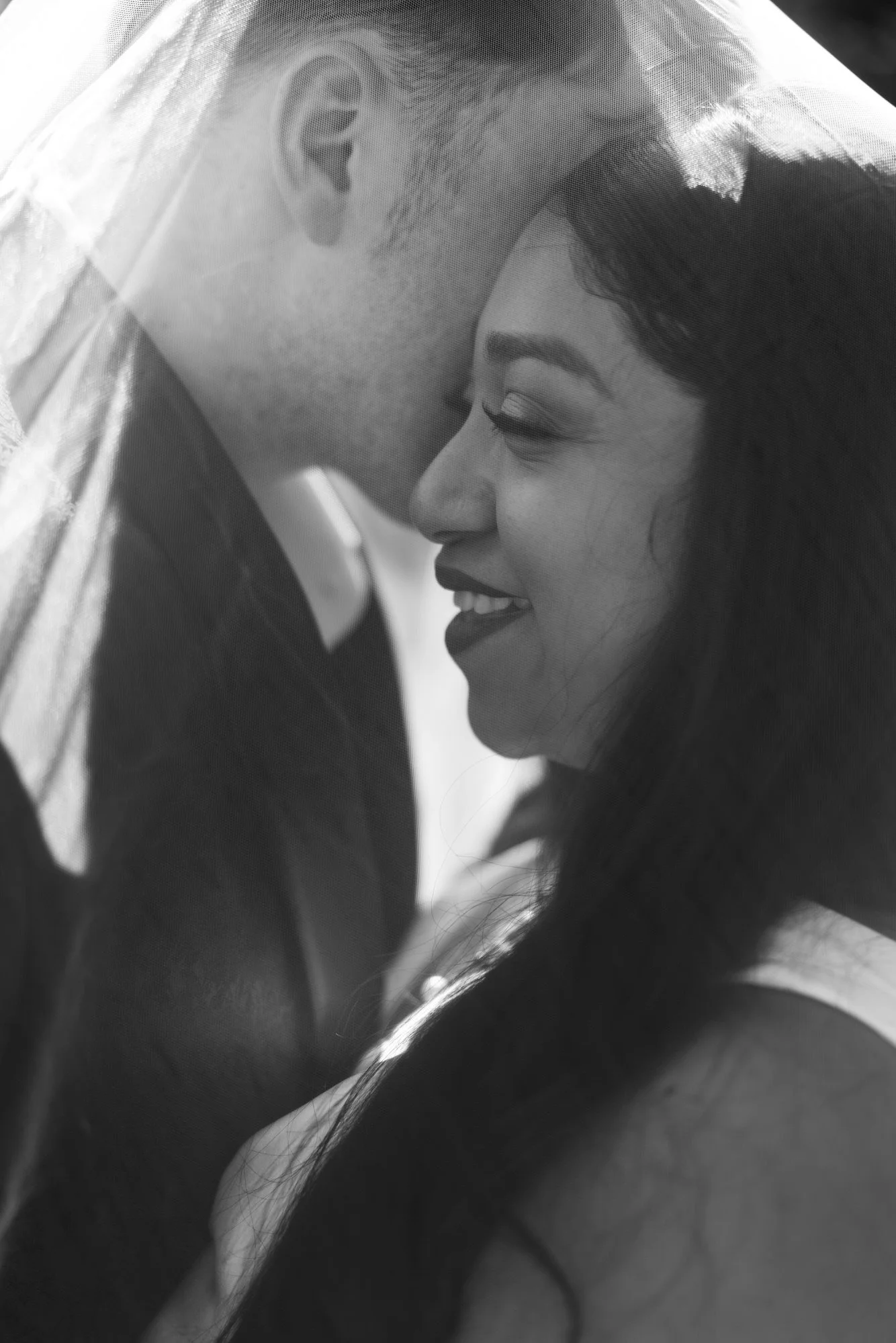 A close black and white portrait beneath the veil