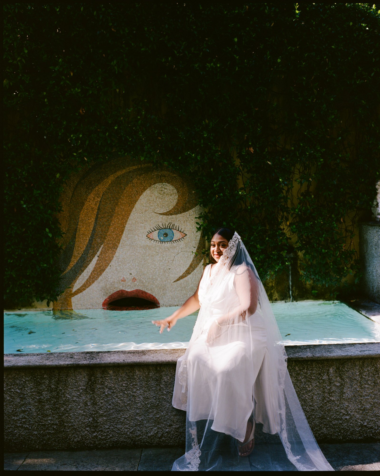 Velia sitting beside a painted mural