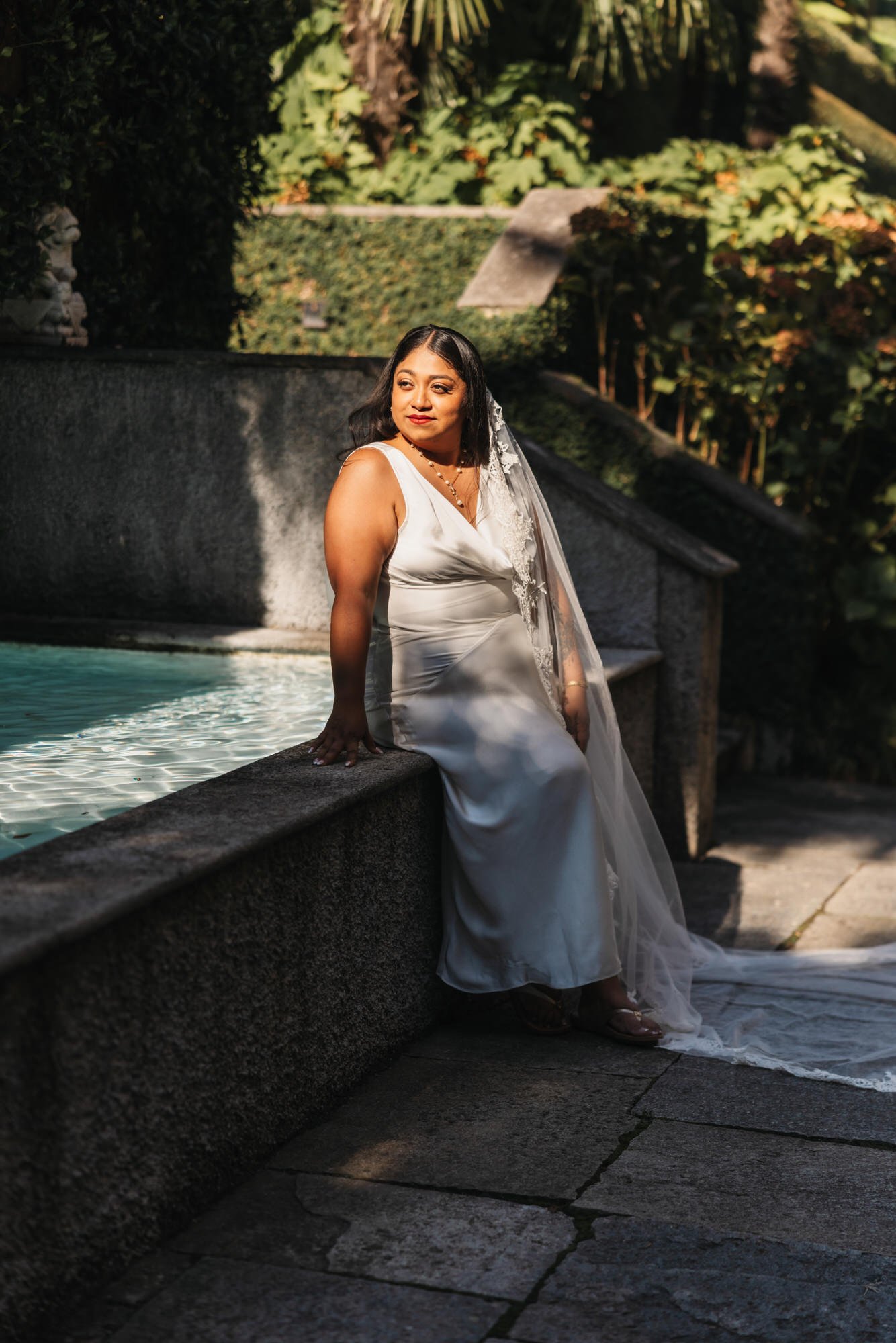 Velia beside the stone pool in the gardens