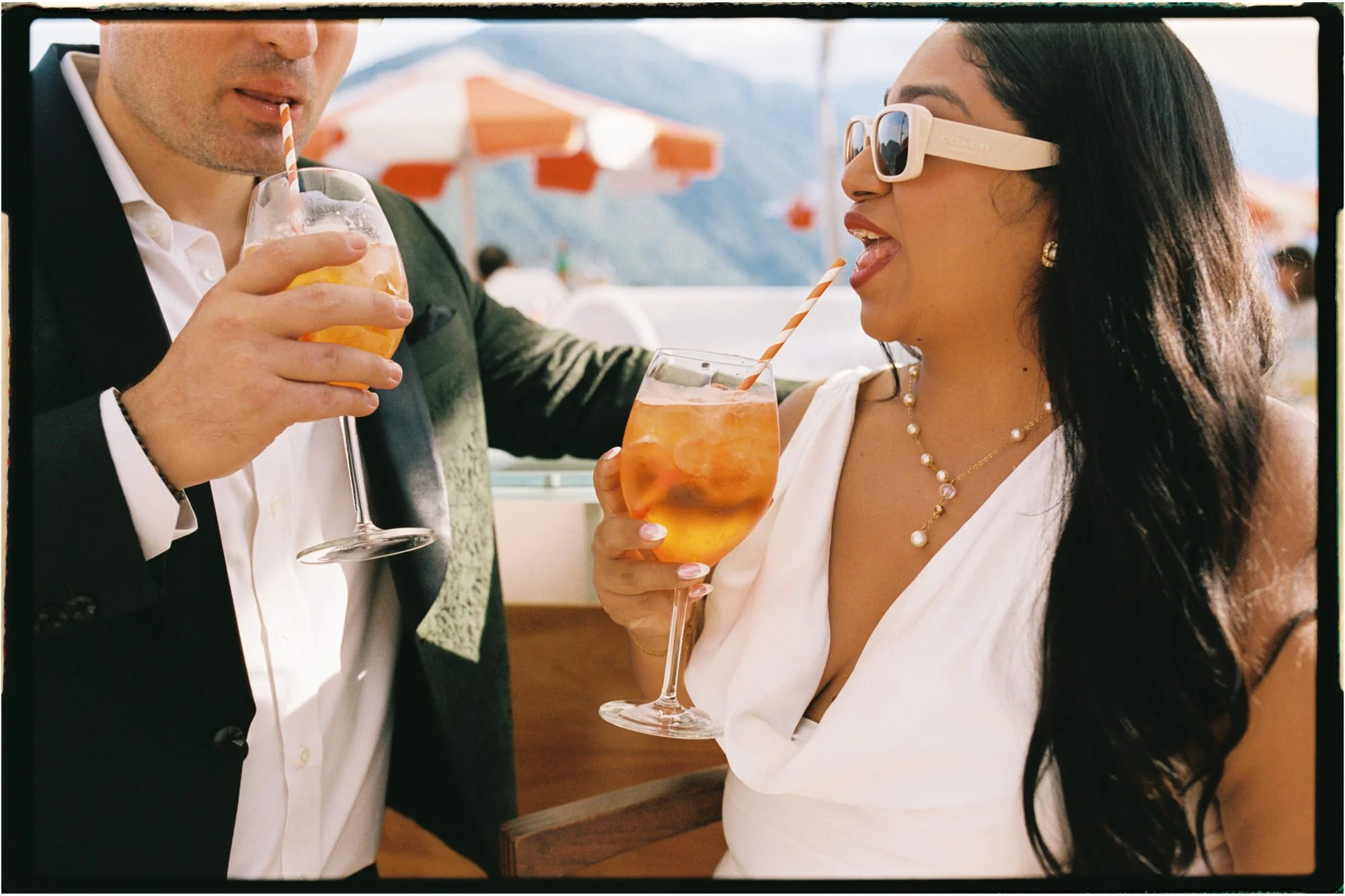 Velia and Dan sharing drinks beside the lake
