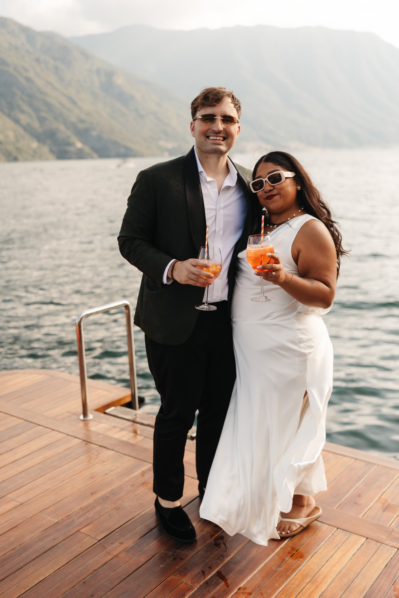 Velia and Dan standing on the wooden lakeside deck