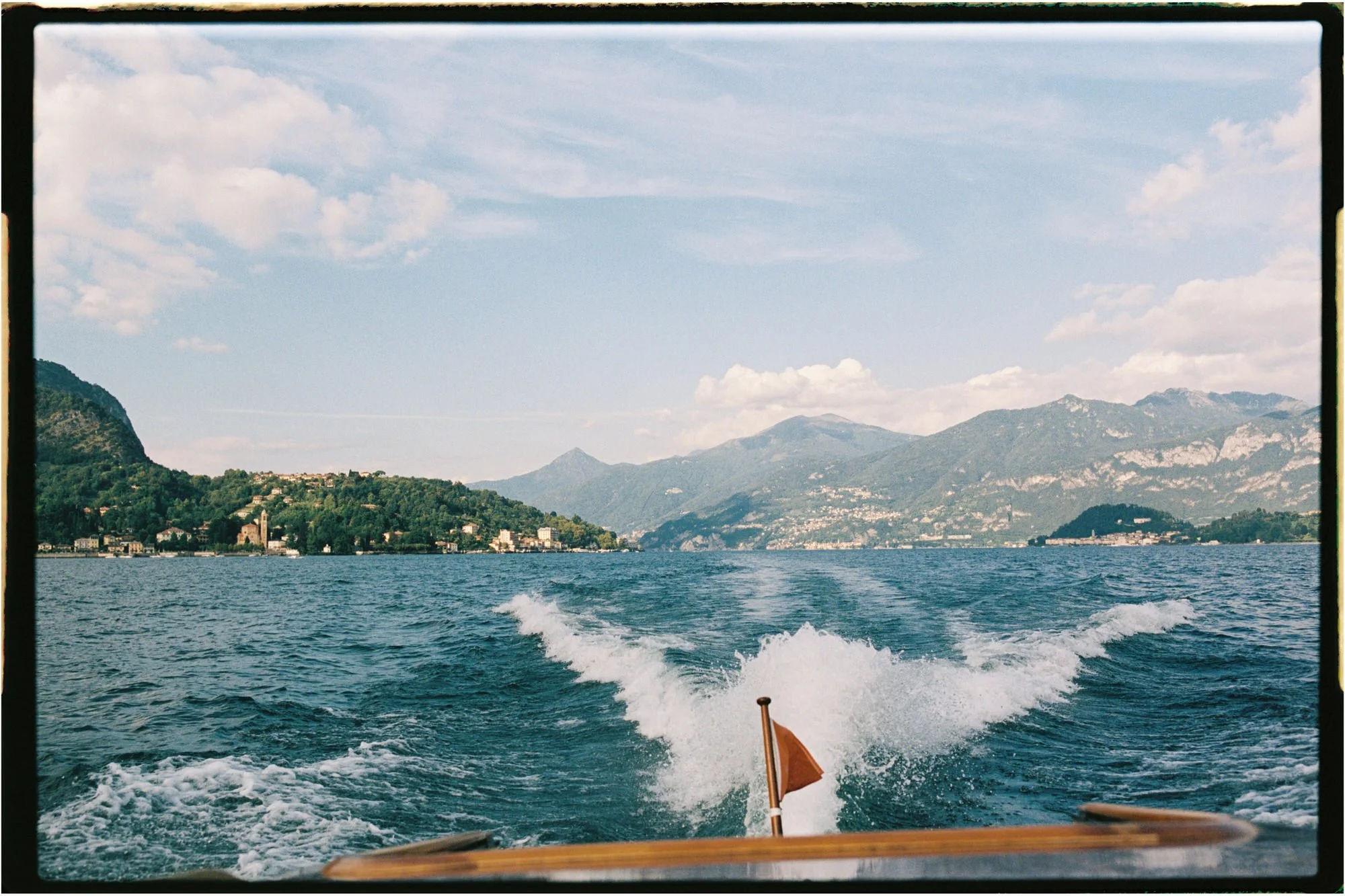 The boat’s wake stretching back towards the mountains