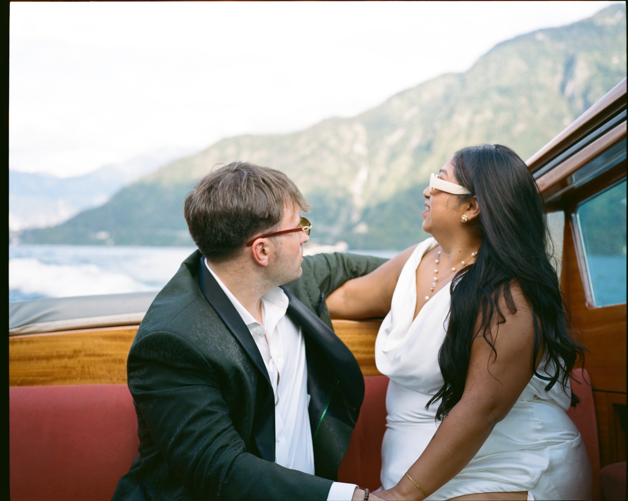 Velia and Dan smiling at each other on the boat