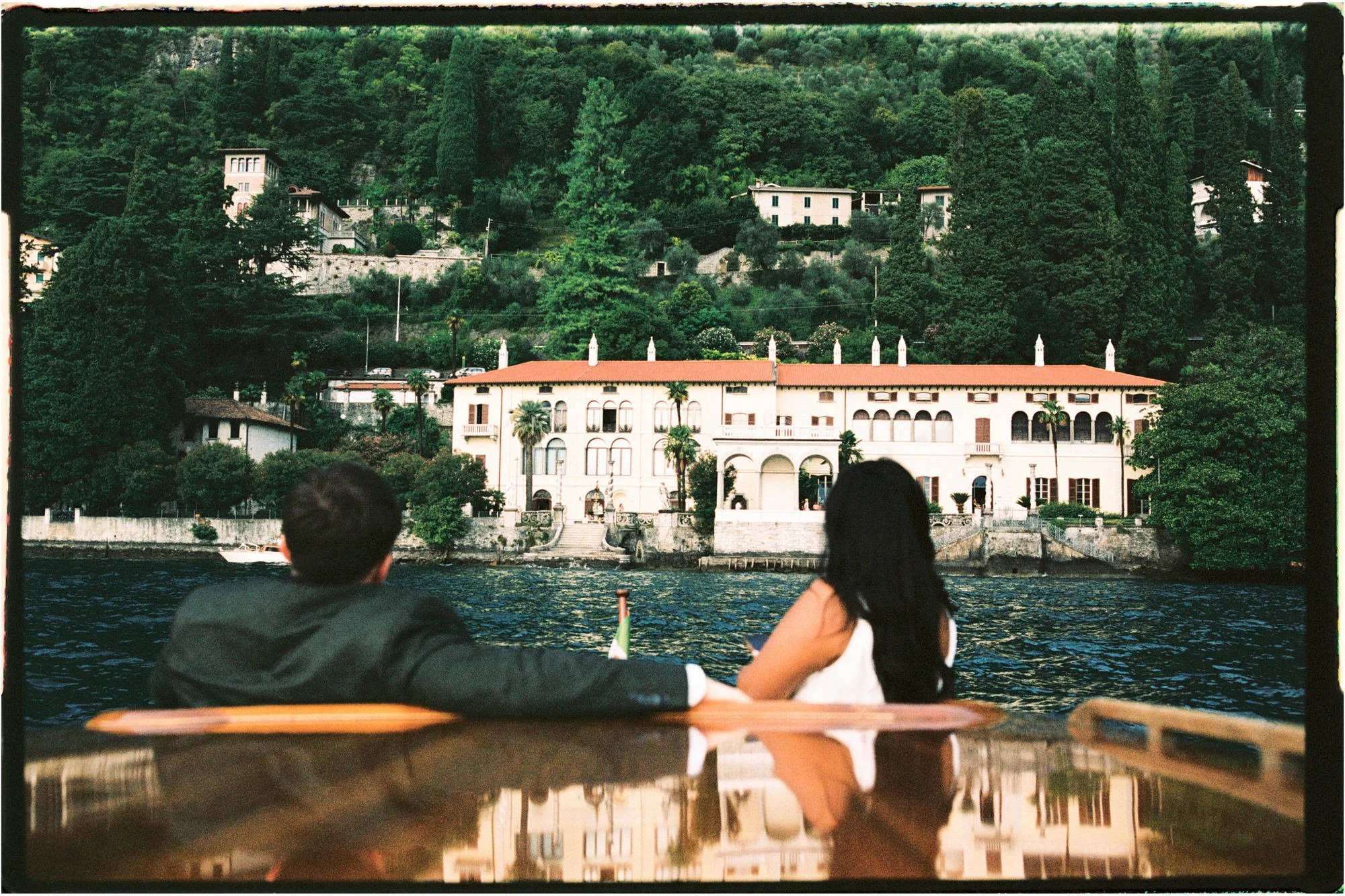 Velia looking towards a lakeside villa from the boat