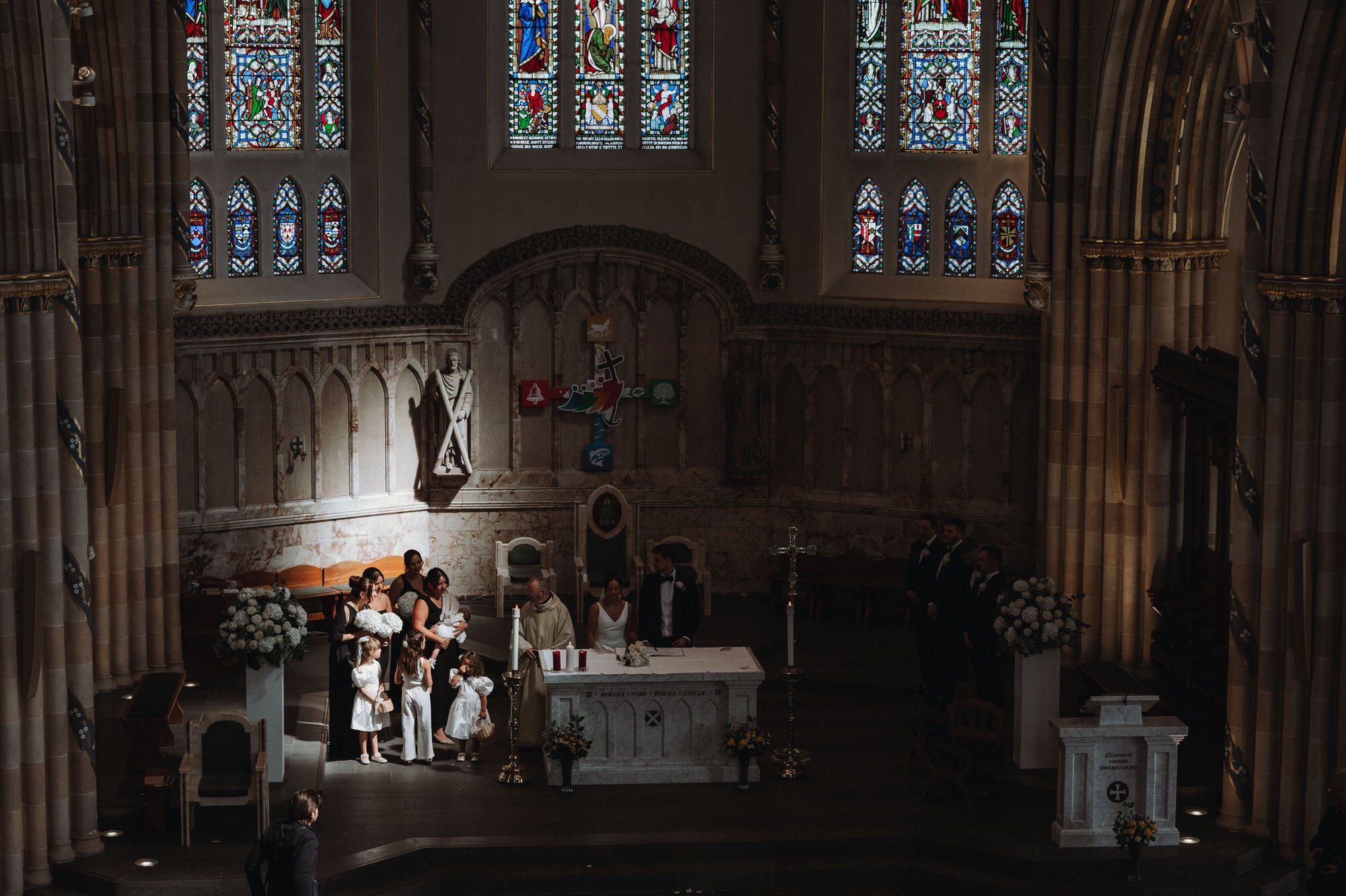 wedding part at alter in a church light shine son the bridesmaids