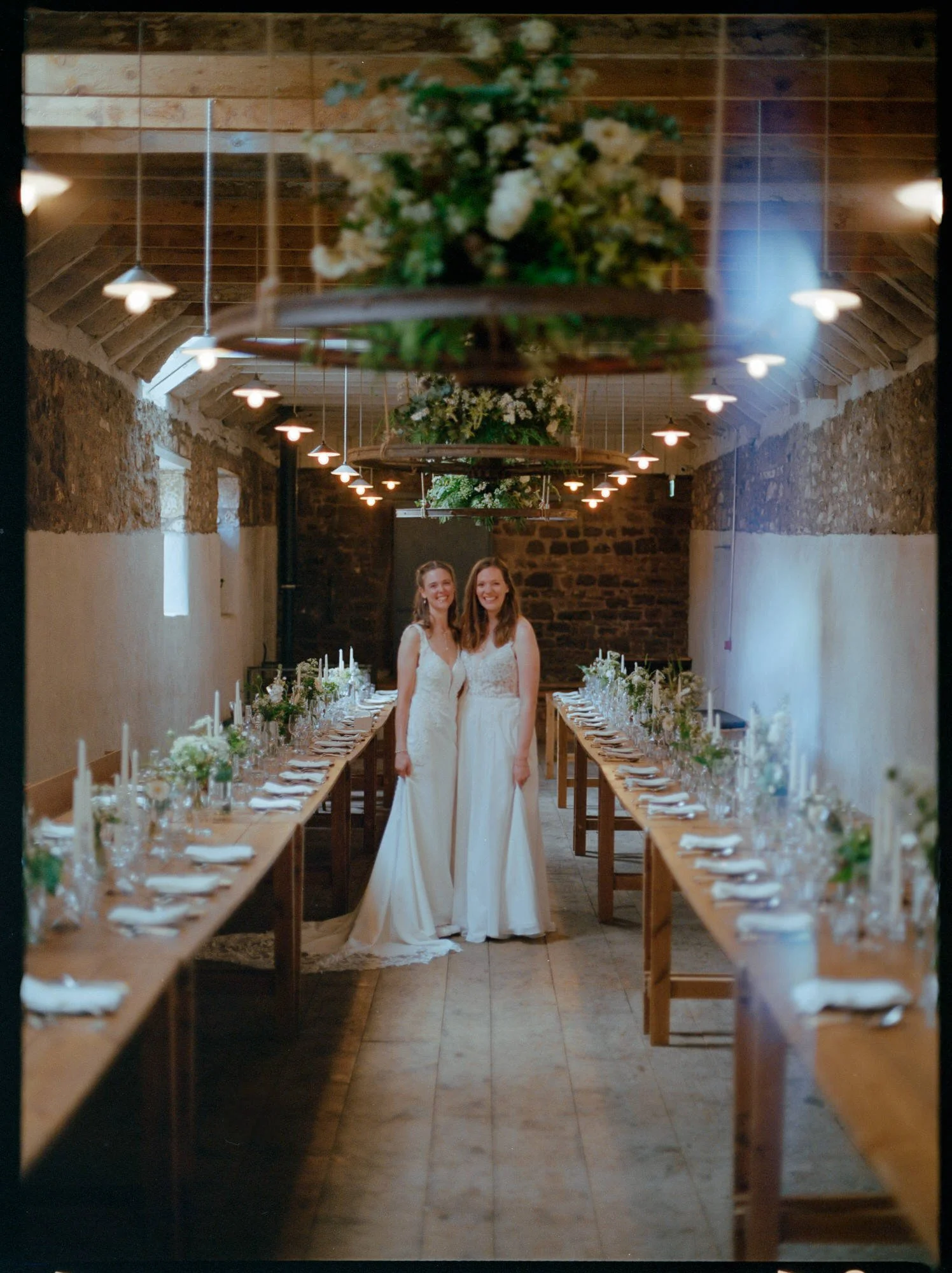 Bride standing between long reception tables at an Edinburgh wedding venue