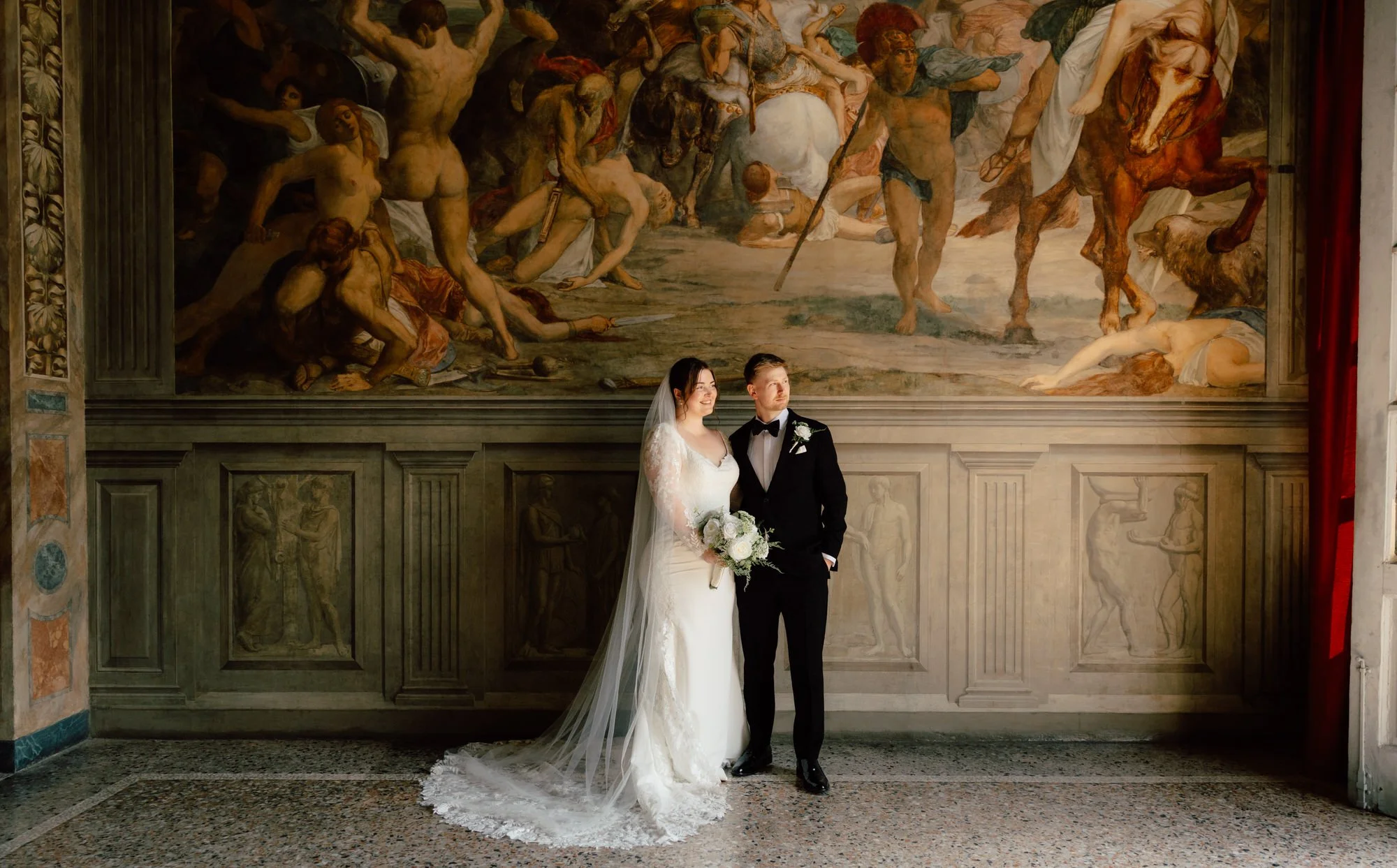 Bride and groom portrait beneath an ornate painted ceiling