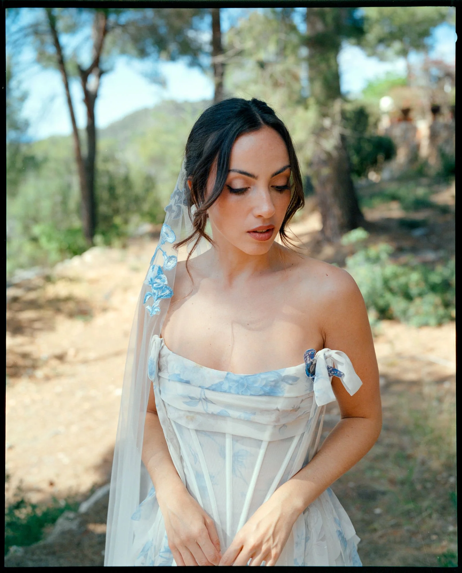 portrait of a bride in a white and blue wedding dress