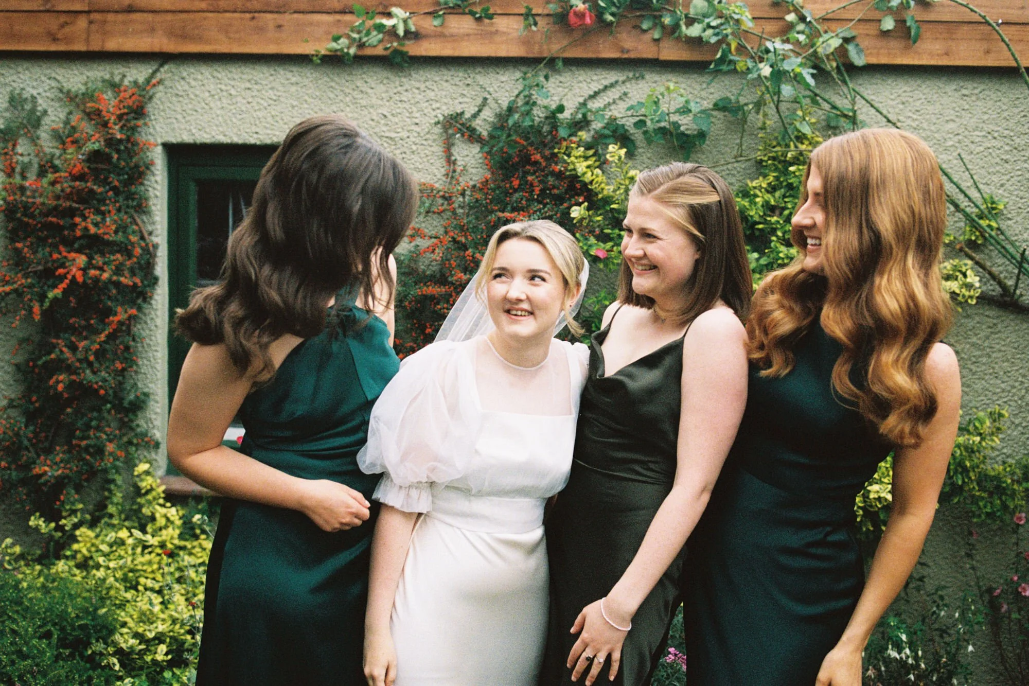 Bride laughing with friends outside an Edinburgh wedding venue