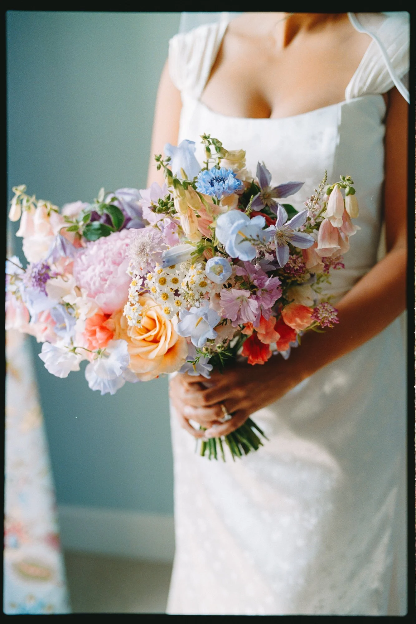 Film photo with borders of brides flowers - the flowers are bright and colourful
