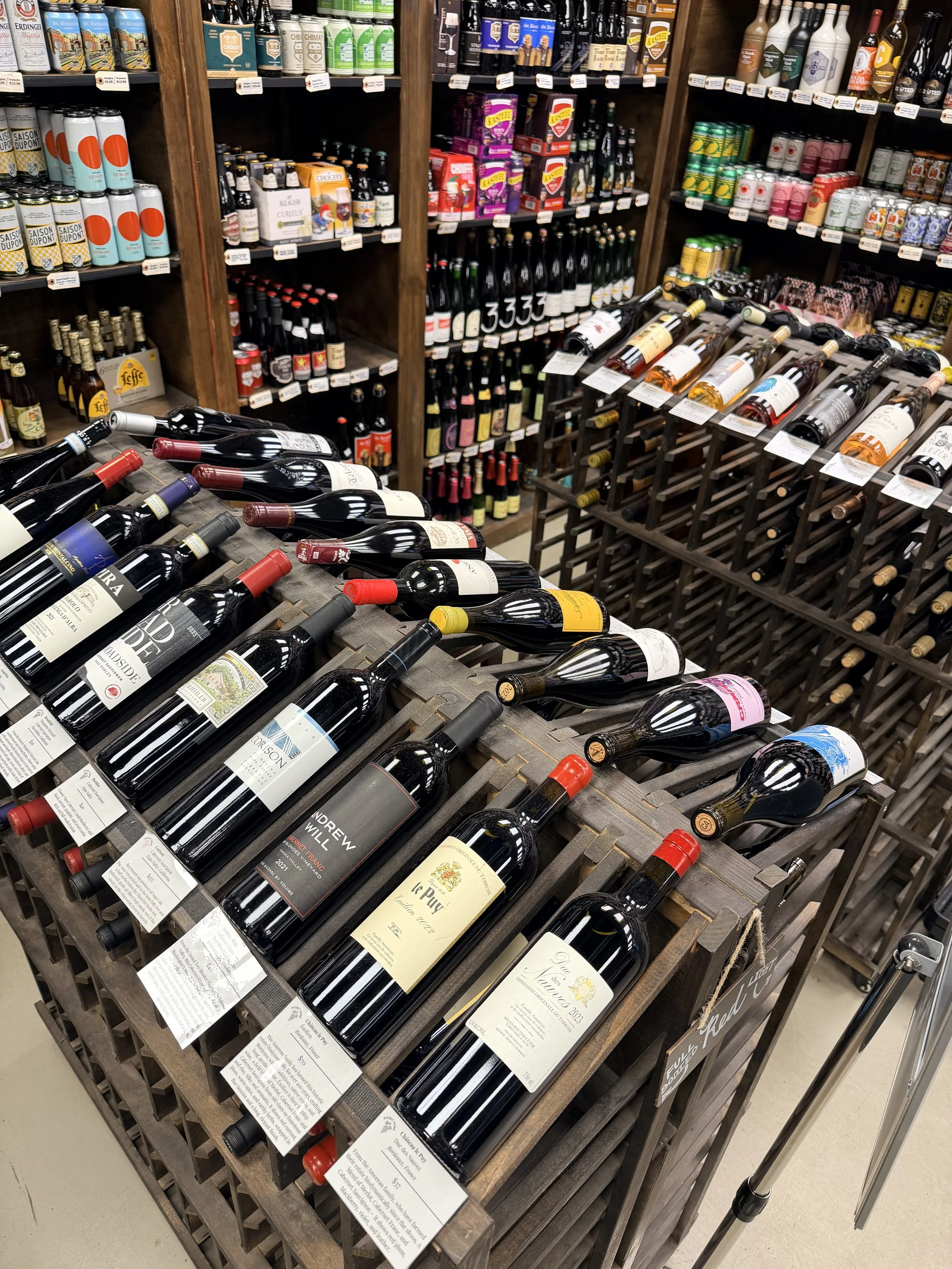 A high-angle, top-down view of the premium red wine shelves at Greenville Beer Exchange.