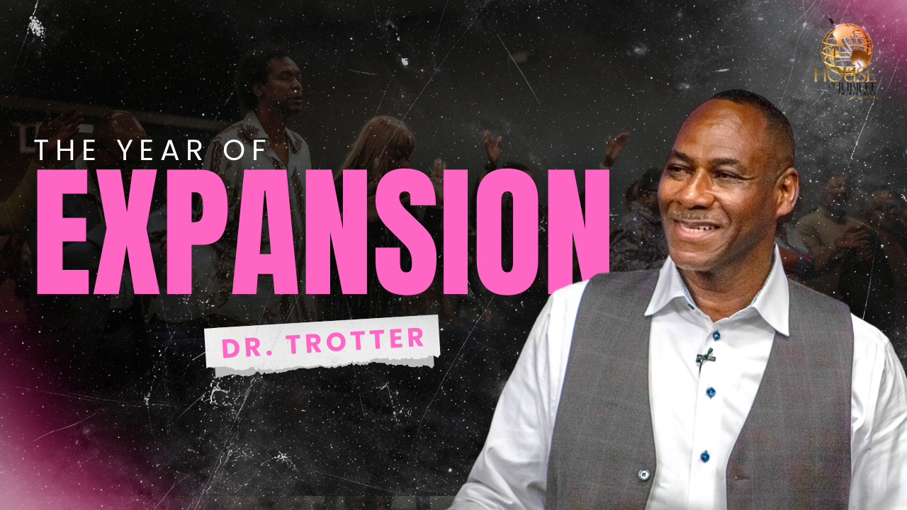 A smiling man wearing a gray vest and white shirt standing in front of a crowd of people against a starry background with pink and white text that reads 'The Year of Expansion' and 'Dr. Trotter'.