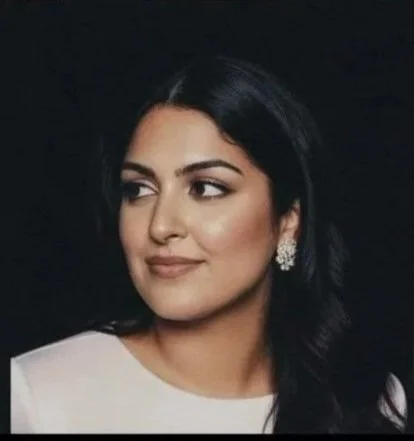 Cindy Kumar, CPA and financial strategist, in a white top against a dark background — professional brand portrait, It's Cindy Kumar