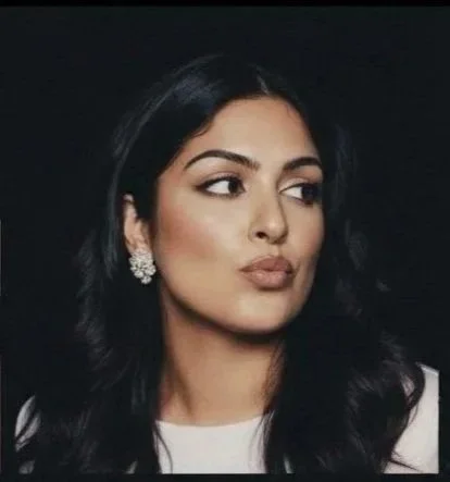 Cindy Kumar, CPA and financial strategist, in a white top against a dark background — professional brand portrait, It's Cindy Kumar
