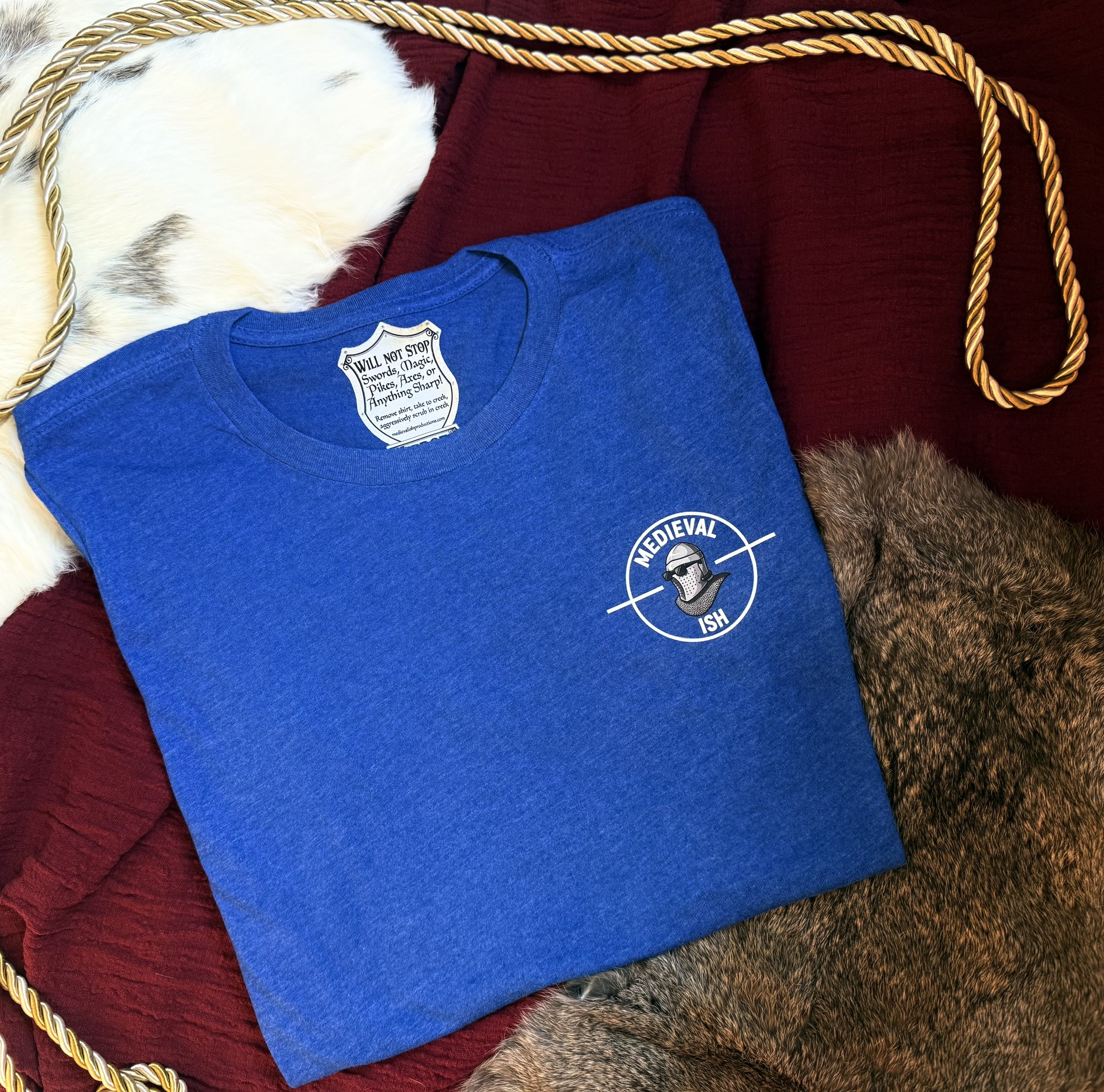 Royal blue womens shirt with medievalish logo on the front left