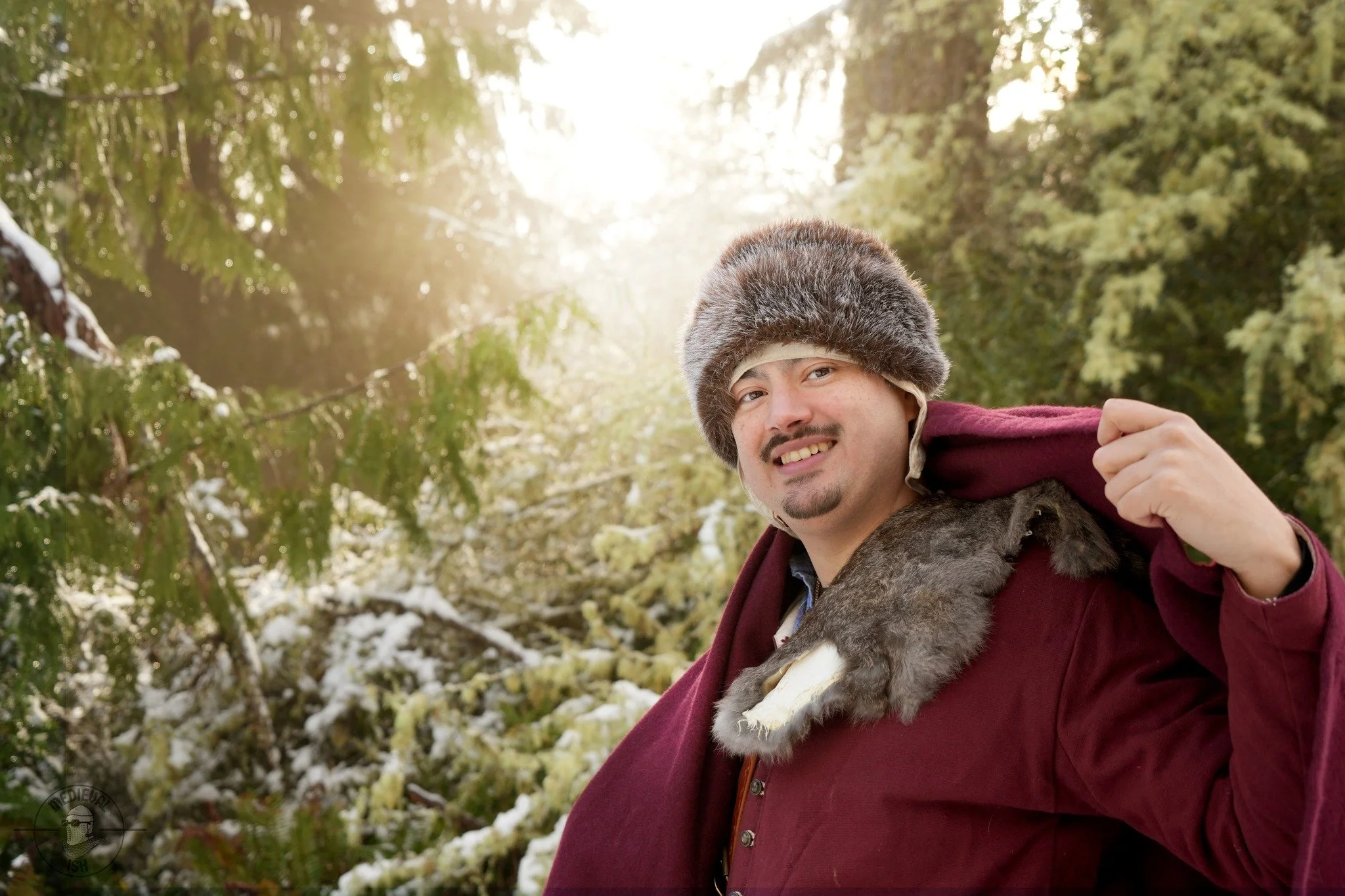 Abrahan wearing a fur hat, red cloak and medieval outfit