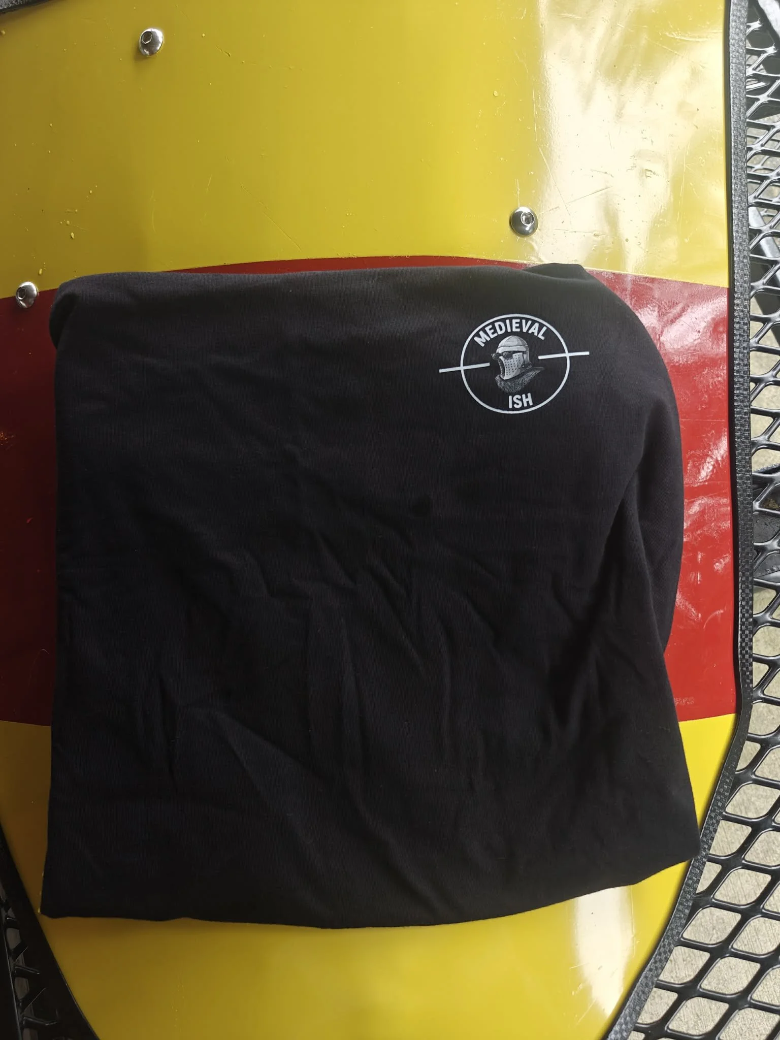 Mens black tee shirt with medievalish logo front left