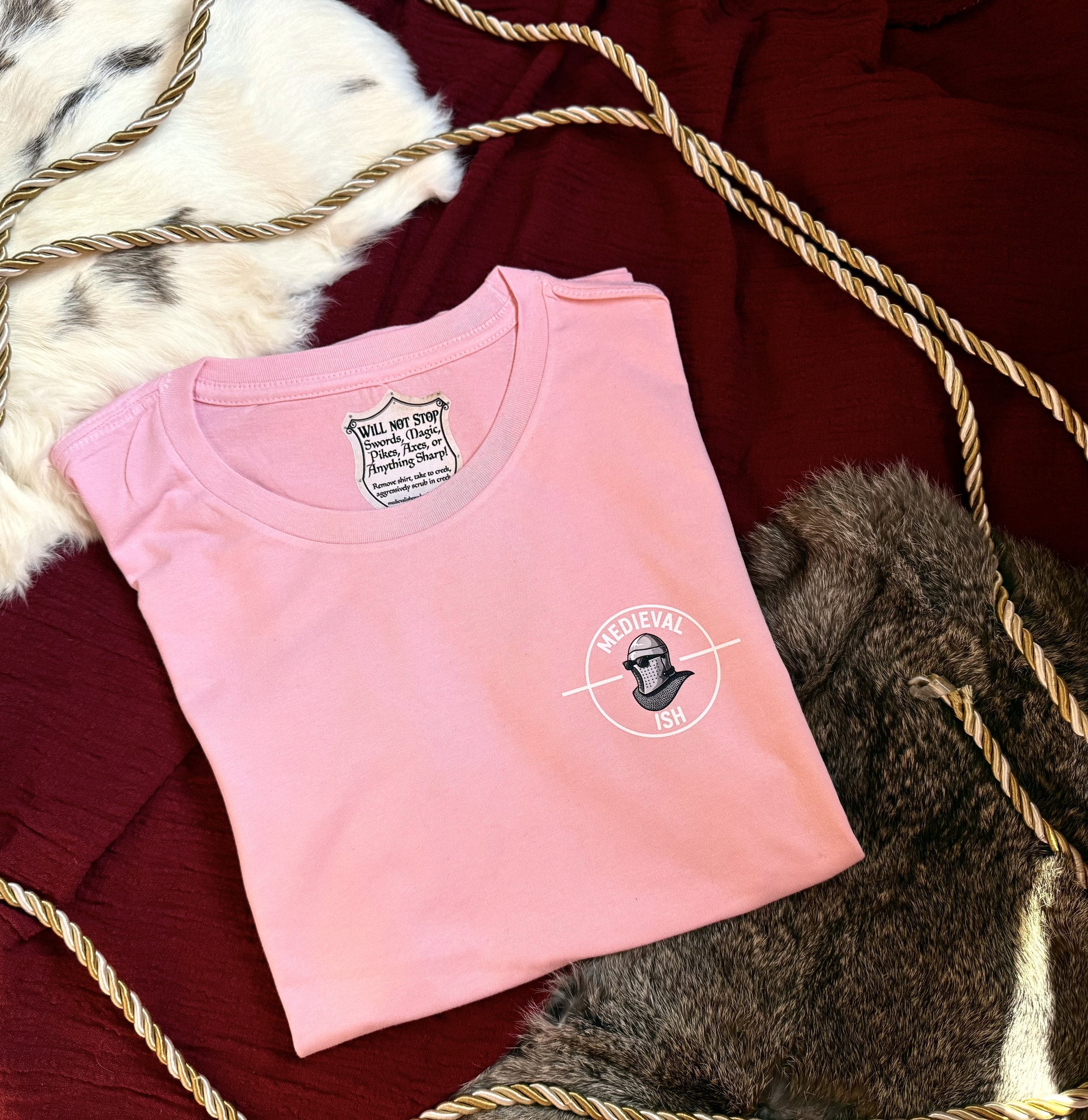 Pink womens shirt with medievalish logo front left