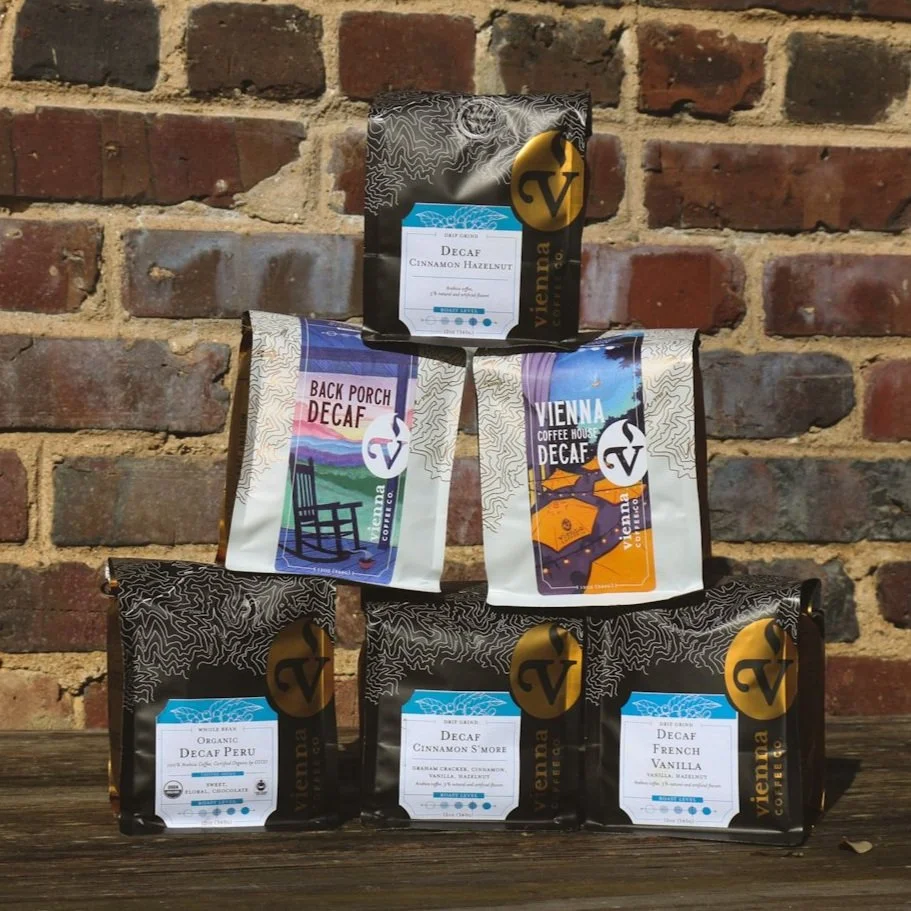 Pyramid stack of bagged Vienna Coffee Company Decaf coffees