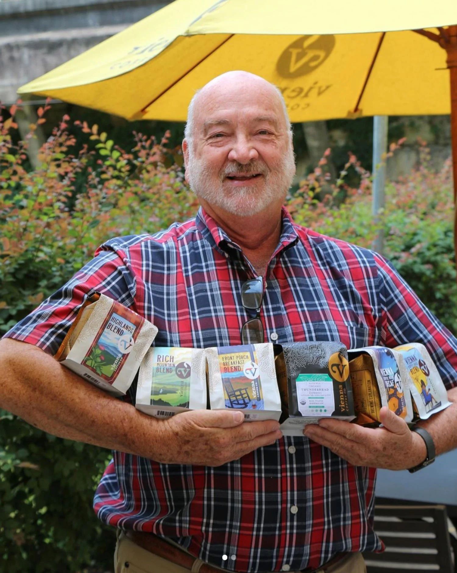 John Clark holding all of his favorite coffees