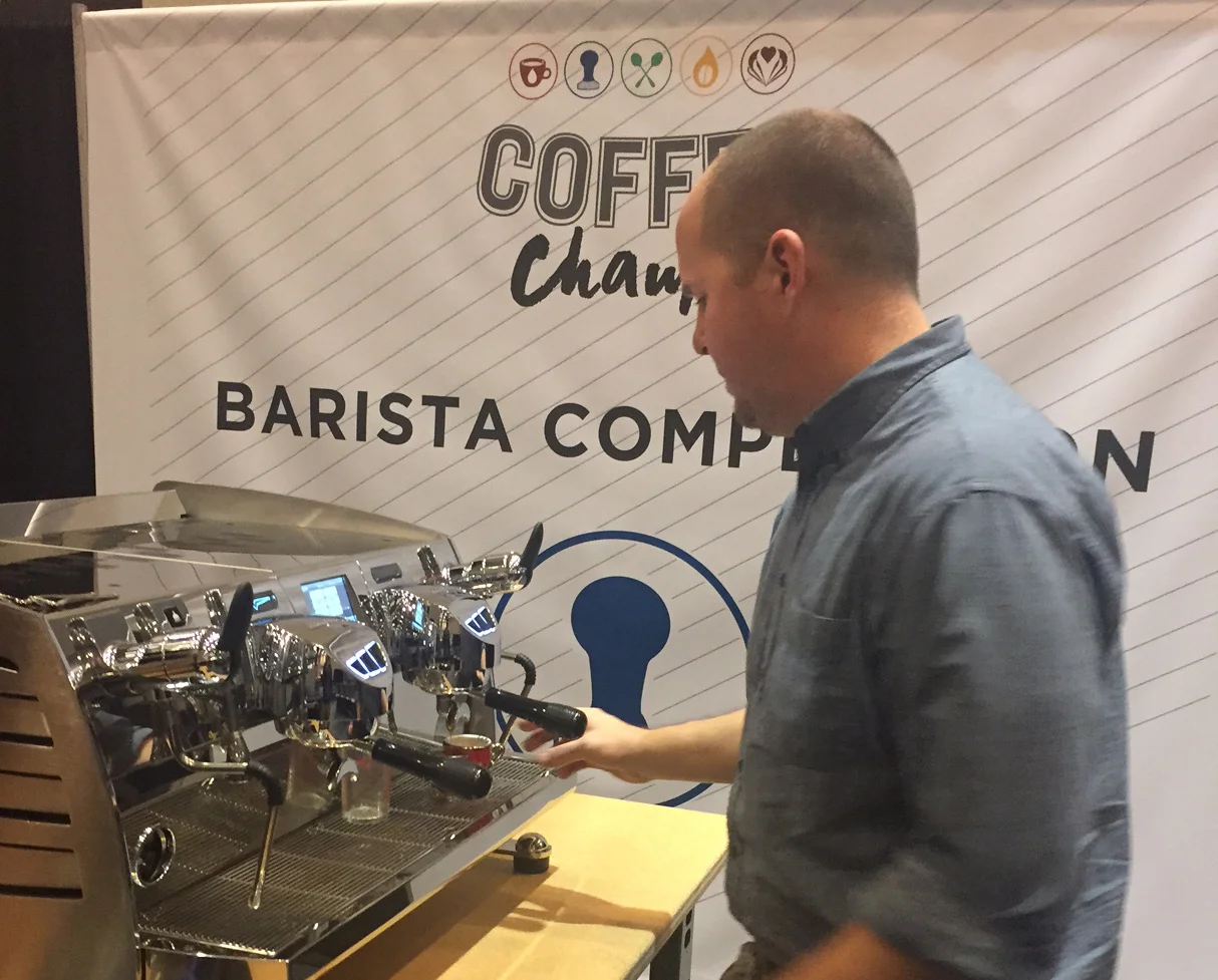 Jon Lewis, with our friends at Deeper Roots Coffee,&nbsp; shares his "Liquid Sunshine" with the judges on stage. He was also gracious enough to leave some of this delicious Kenya AA from the Kiriani Farmers Cooperative Society with us to serve on ou…